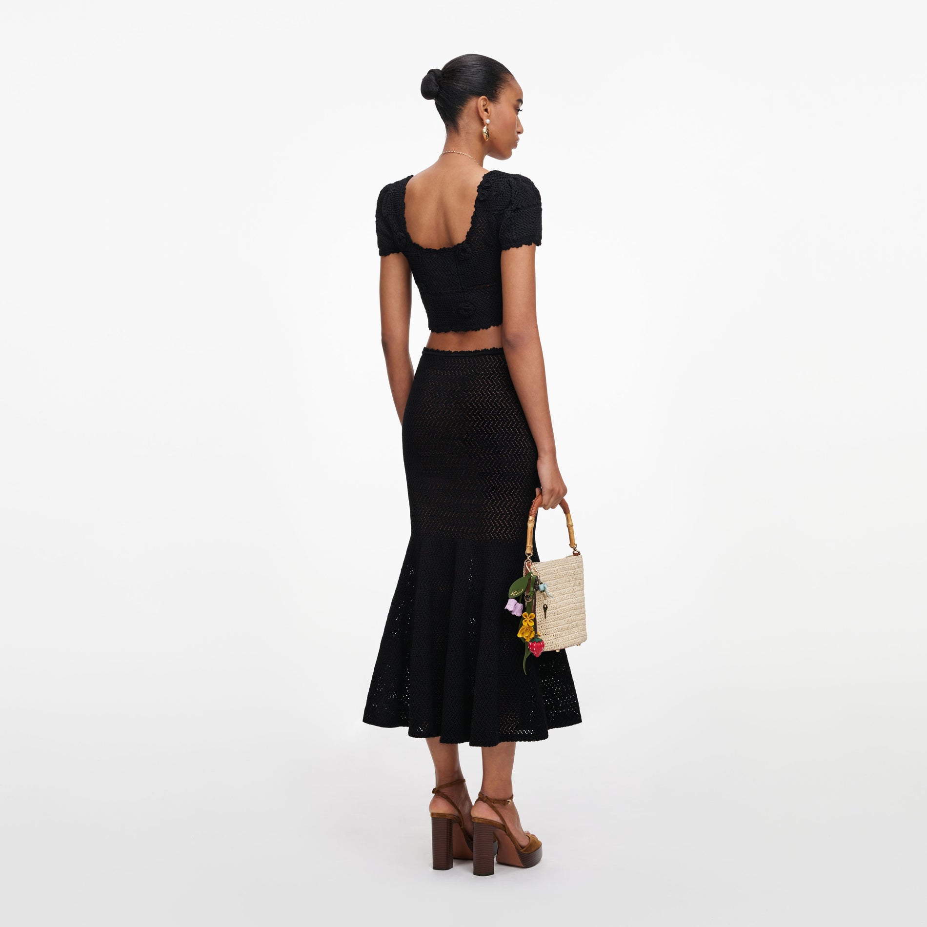 Back view of a woman wearing the Black Crochet Knit Midi Skirt