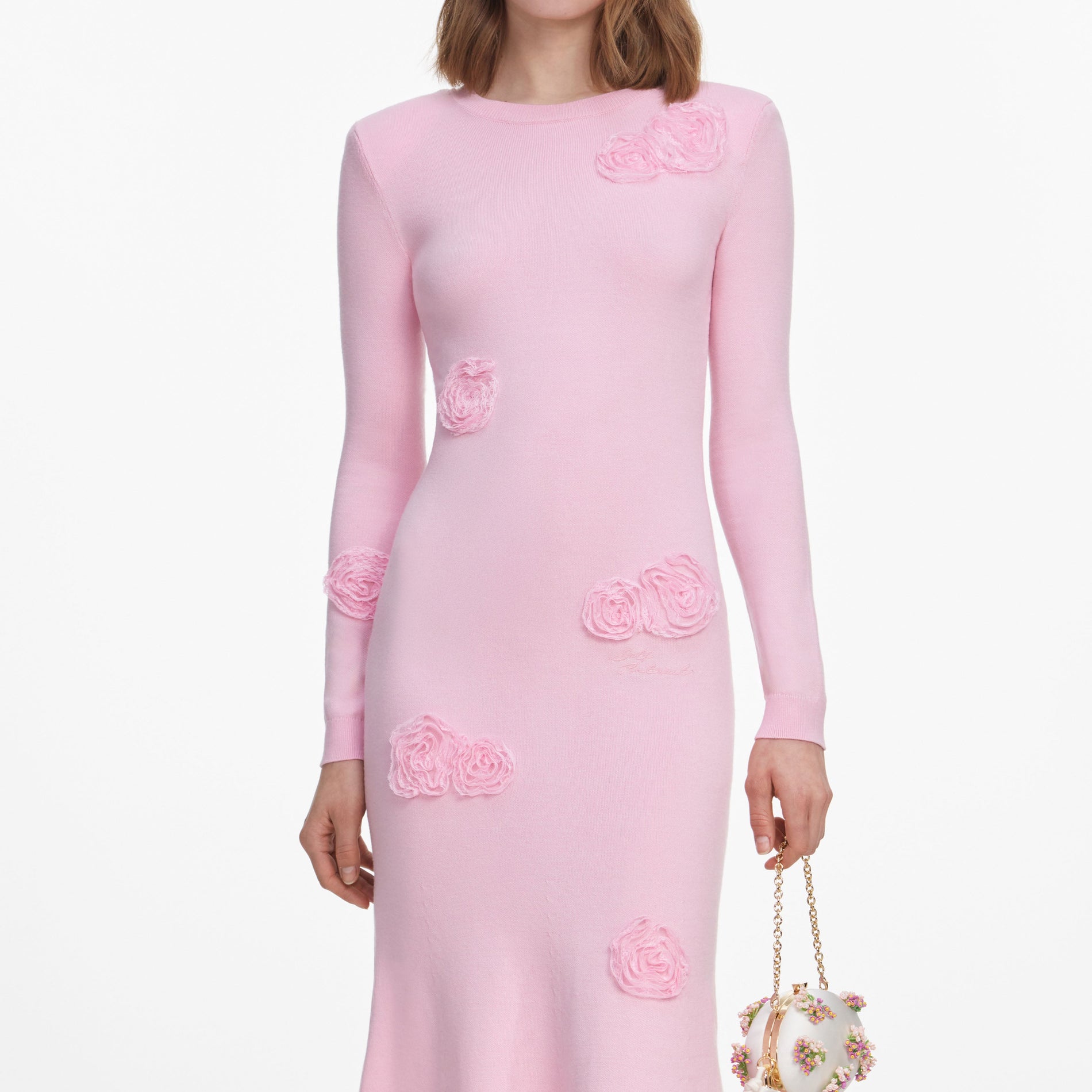 A close up of a woman wearing the Pink Flower Knit Midi Dress