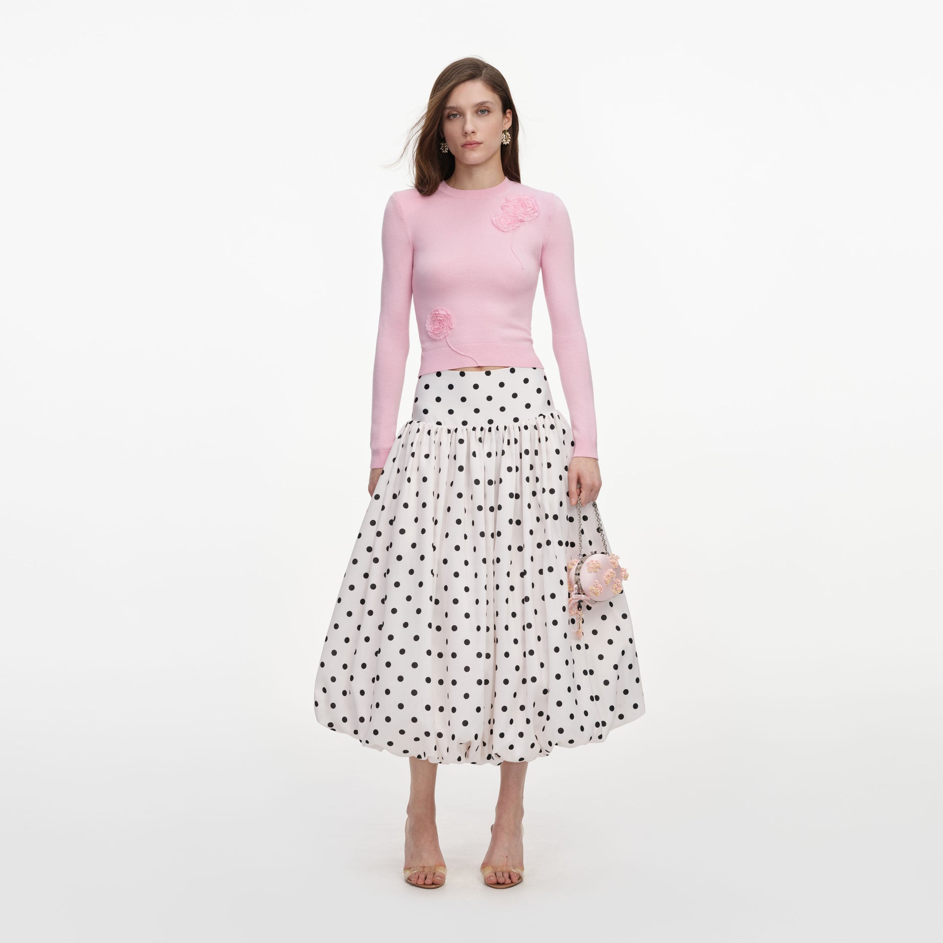 Front view of a woman wearing the Cream Polka Dot Taffeta Midi Skirt