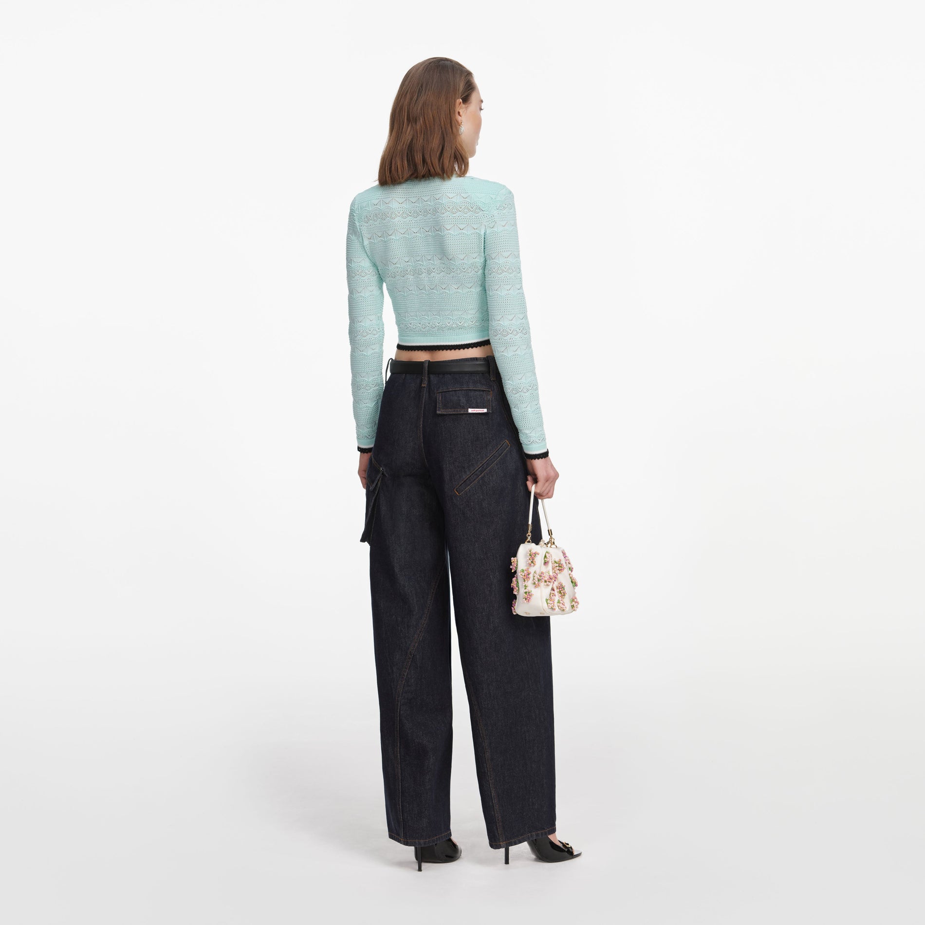 Back view of a woman wearing the Mint Pointelle Knit Cardigan