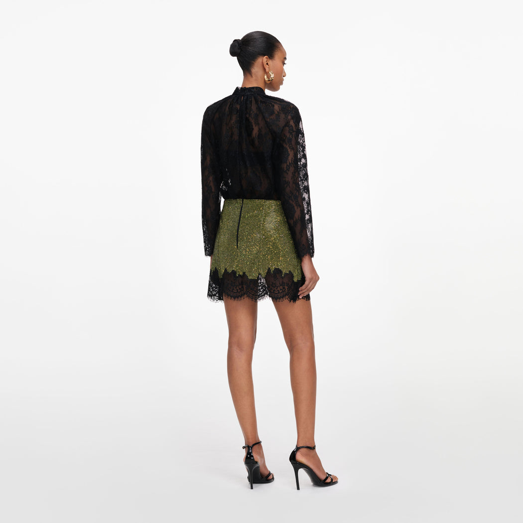 Back view of a woman wearing the Green Crystal Chainmail Mini Skirt