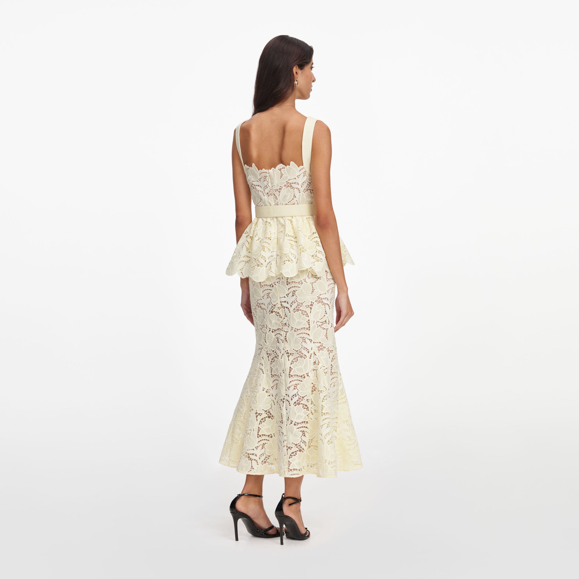Back view of a woman wearing the Yellow Lace Peplum Midi Dress