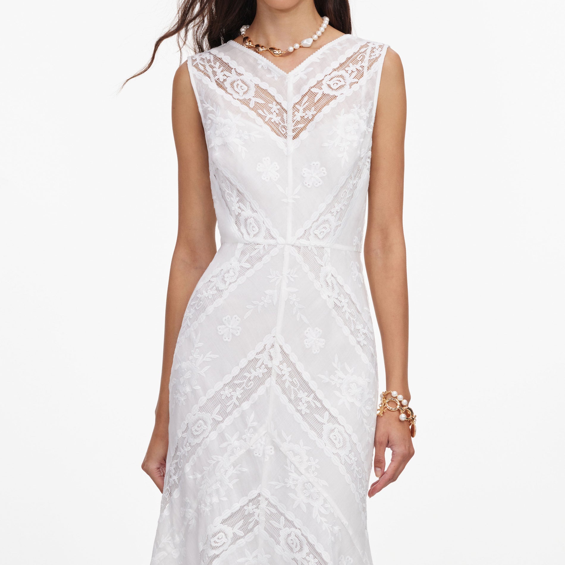 A close up of a woman wearing the White Ramie Sleeveless Midi Dress