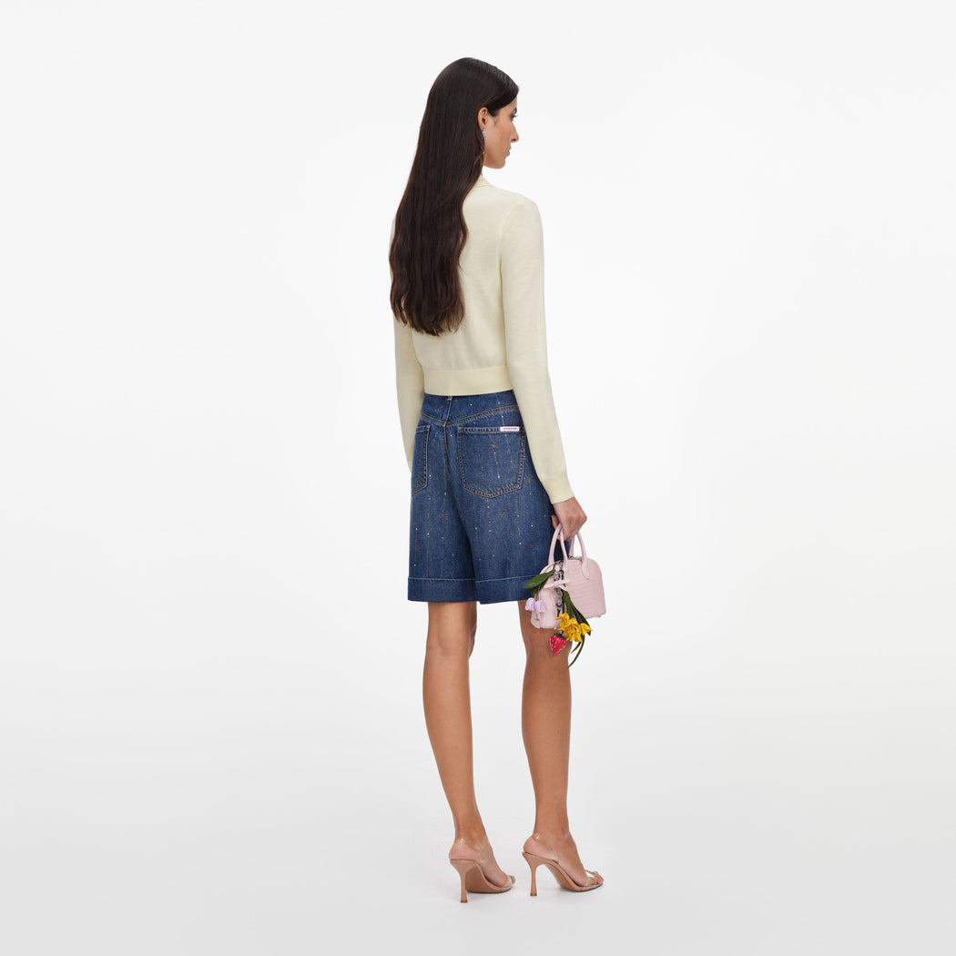 Back view of a woman wearing the Yellow Flower Embroidered Knit Cardigan