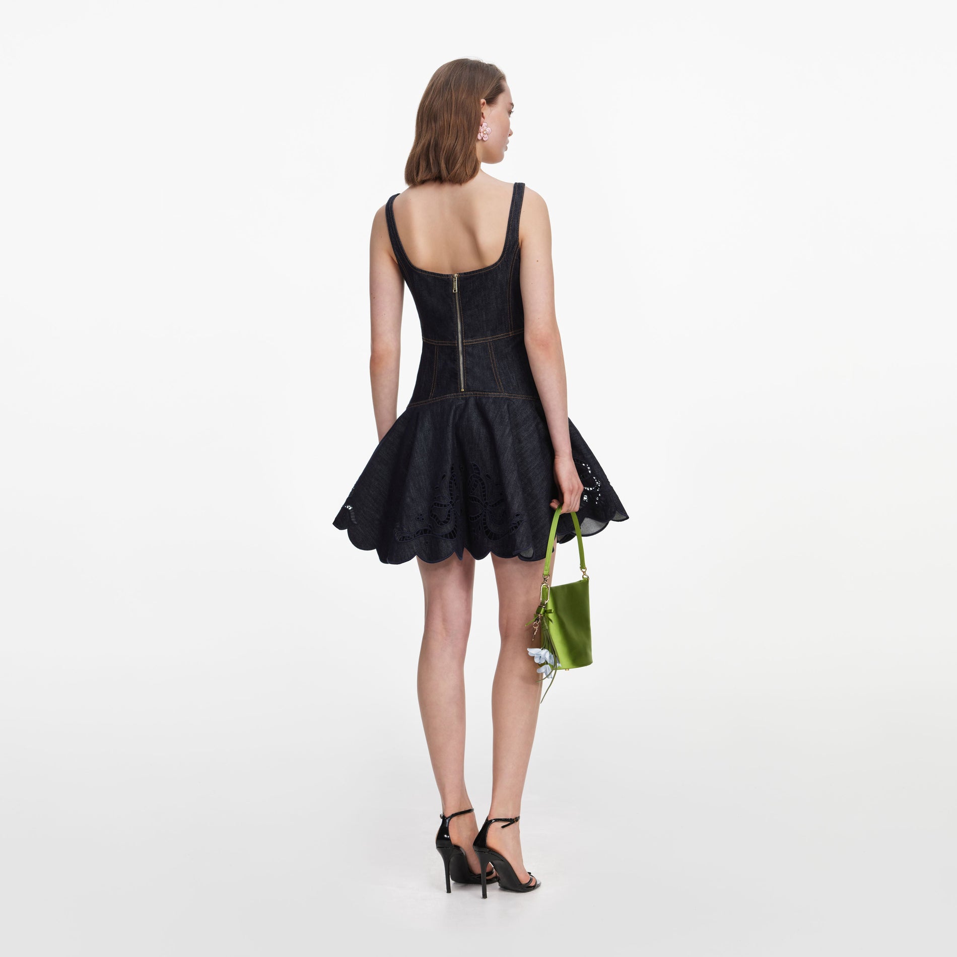 Back view of a woman wearing the Indigo Denim Bow Embroidered Mini Dress