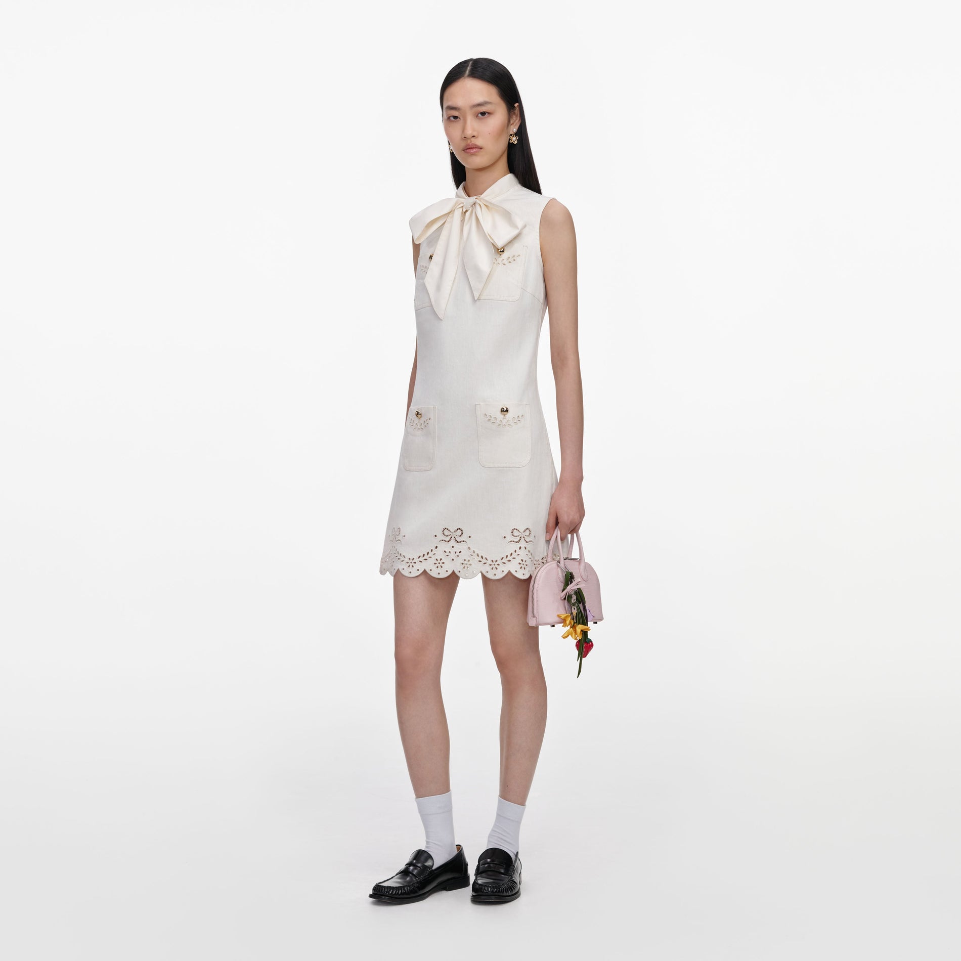 Side view of a woman wearing the Cream Broderie Denim Mini Dress