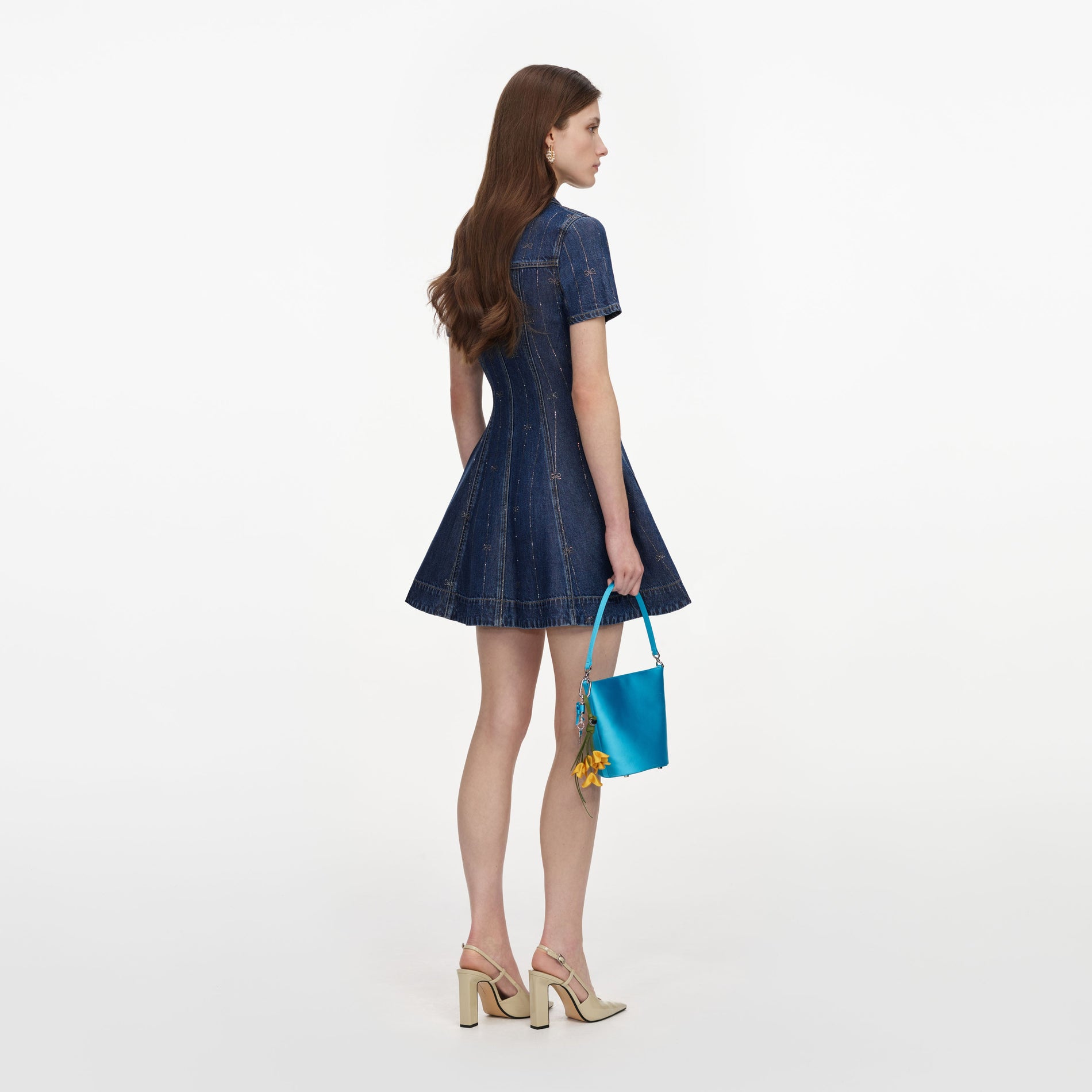 Back view of a woman wearing the Rhinestone Stripe Denim Mini Dress