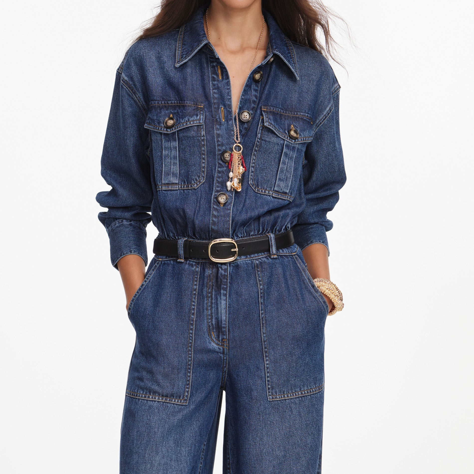 A close up of a woman wearing the Denim Relaxed Fit Jumpsuit
