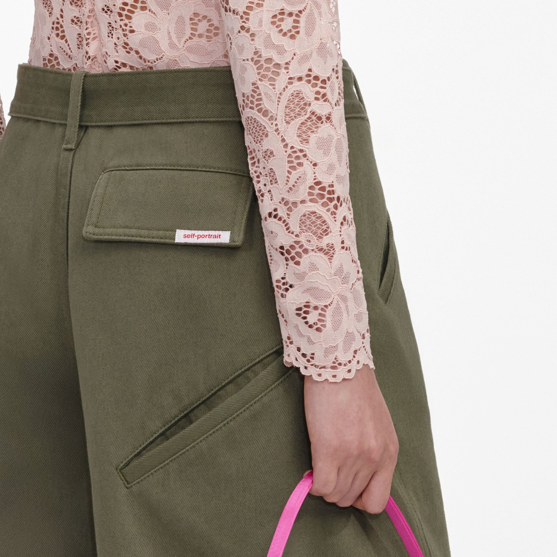 A close up of a woman wearing the Khaki Cargo Jeans