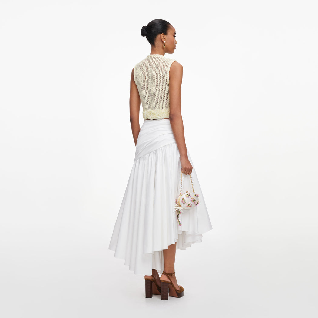 Back view of a woman wearing the Yellow Crochet Flower Knit Top