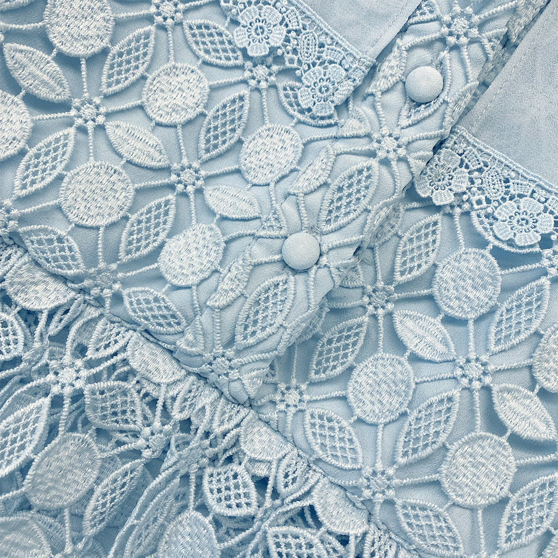 A close up of the fabric for the Blue Lace Dress With Double Collar