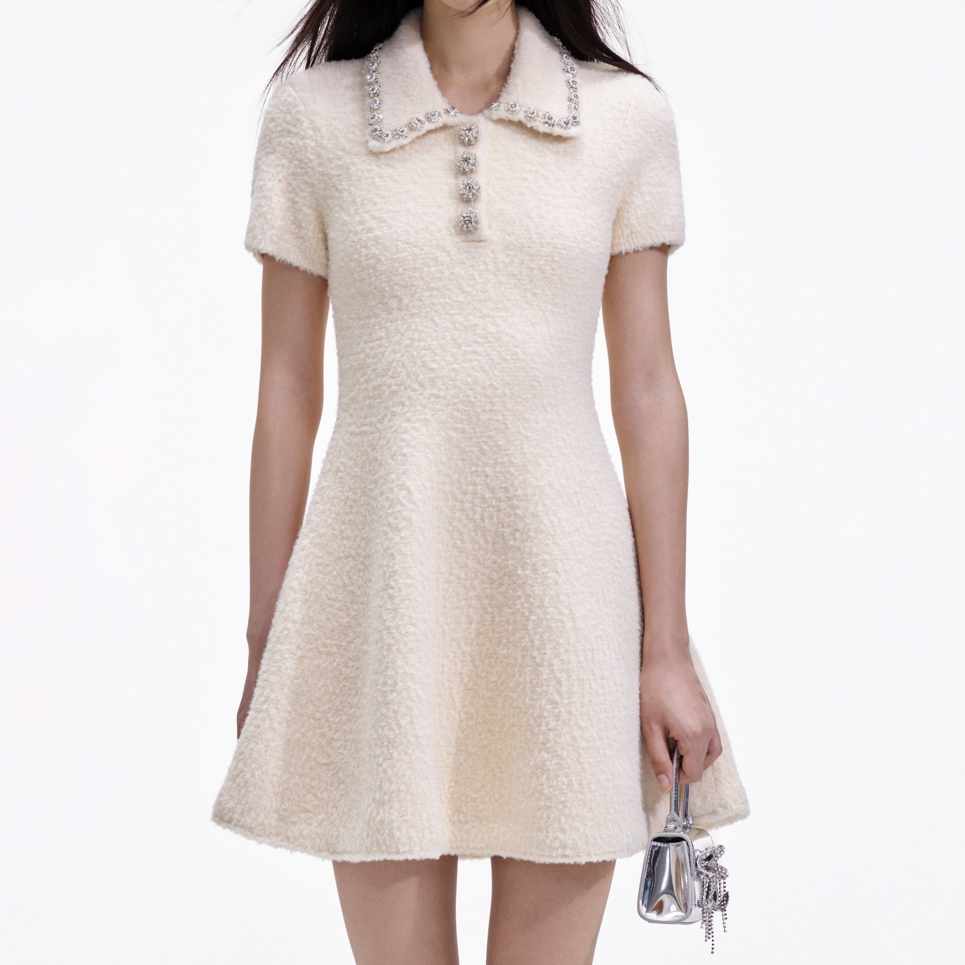 A close up of a woman wearing the Cream Soft Knit Mini Dress