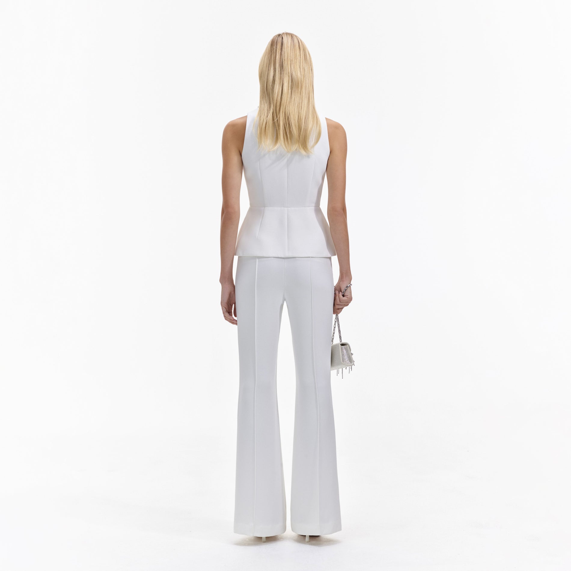 Back view of a woman wearing the Cream Tailored Jumpsuit