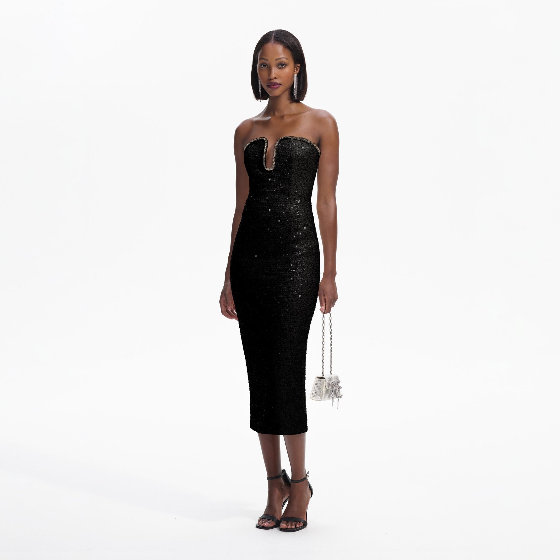 Side view of a woman wearing the Black Sequin Boucle Midi Dress