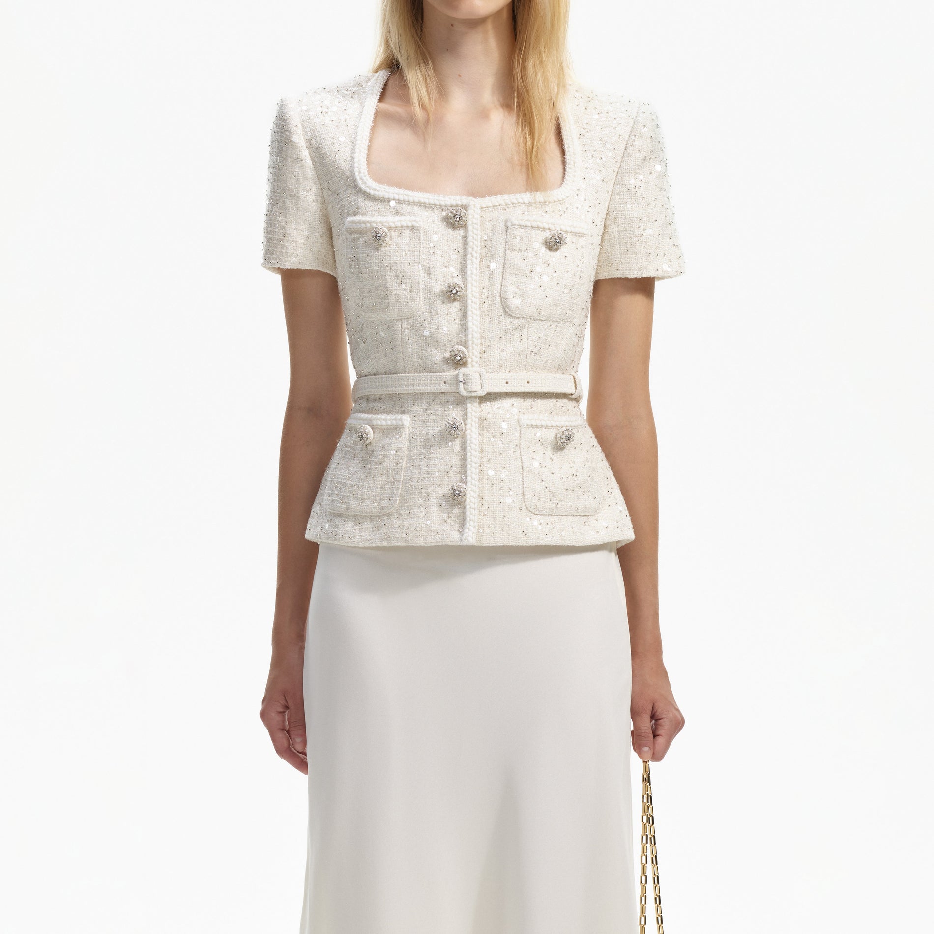 A close up of a woman wearing the Cream Sequin Boucle Midi Dress