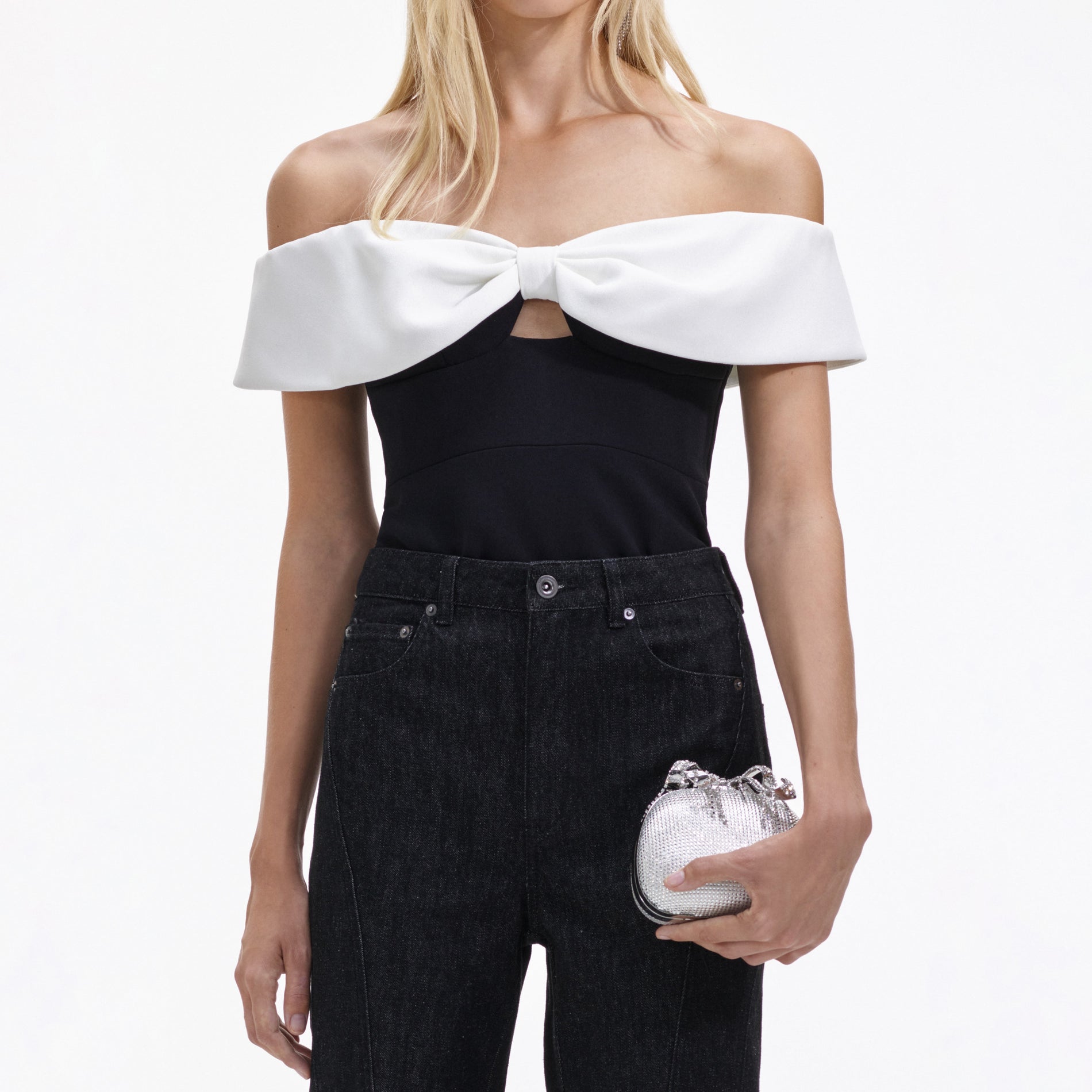 A close up of a woman wearing the Black Crepe Bow Top