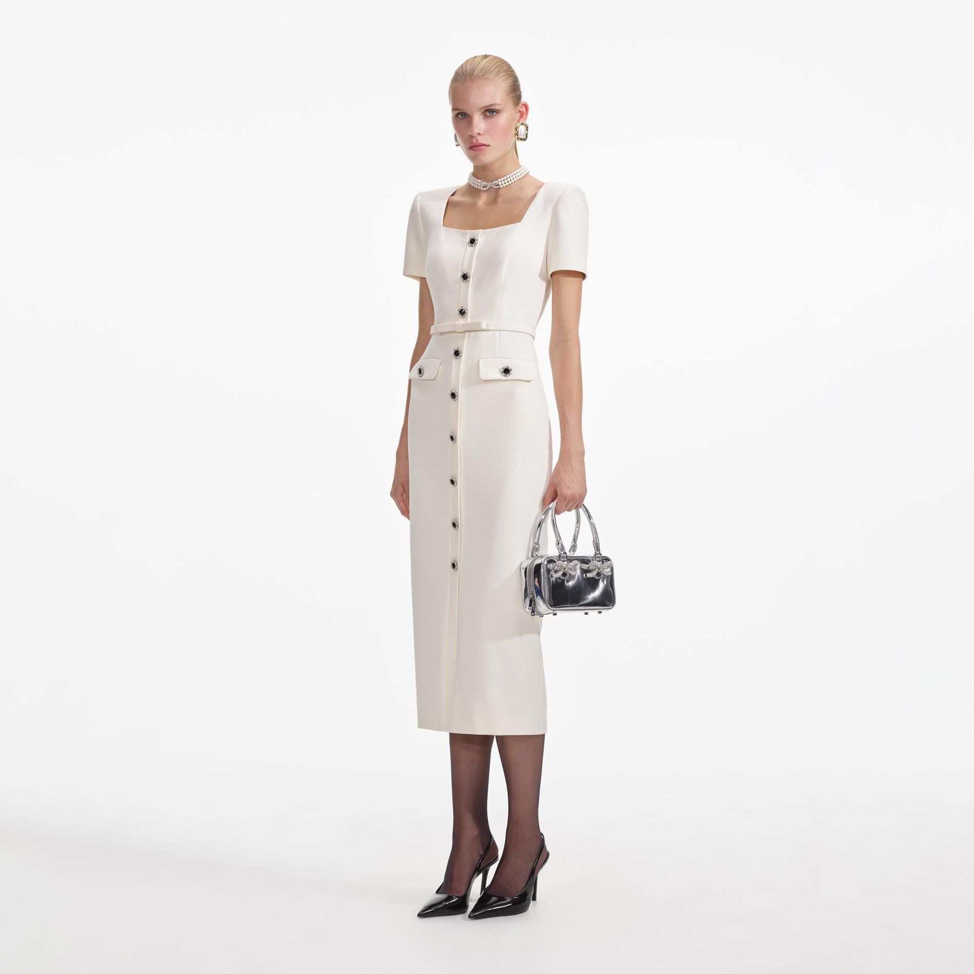 Side view of a woman wearing the Cream Crepe Button Midi Dress