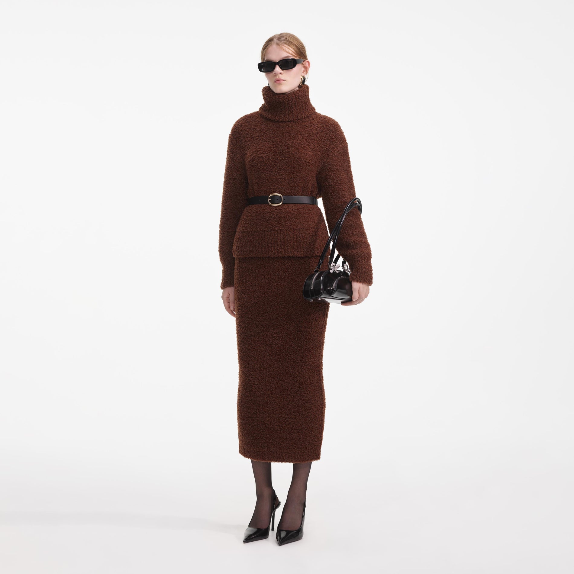 Side view of a woman wearing the Brown Fluffy Knit Midi Skirt
