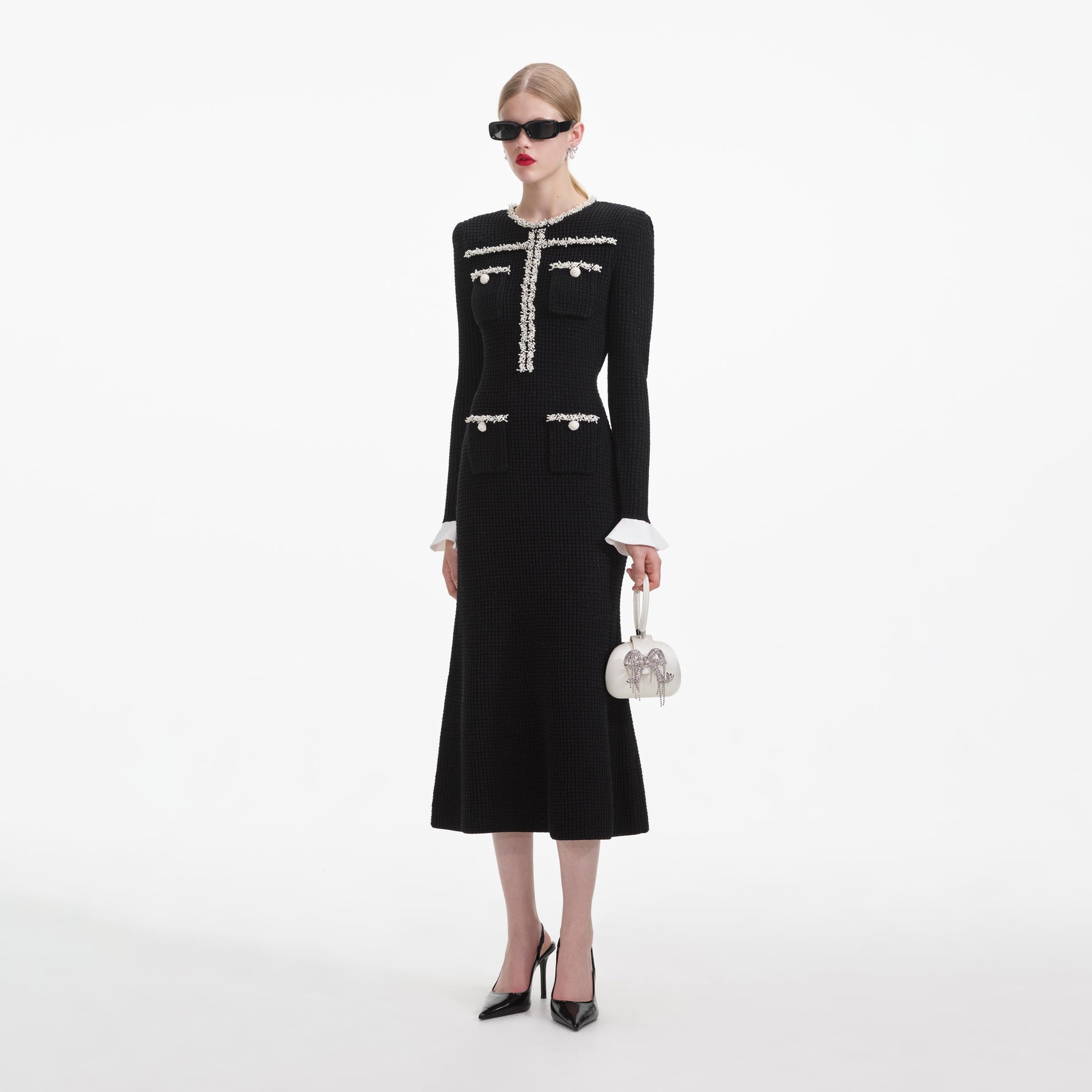 Side view of a woman wearing the Black Pearl Trim Knit Midi Dress