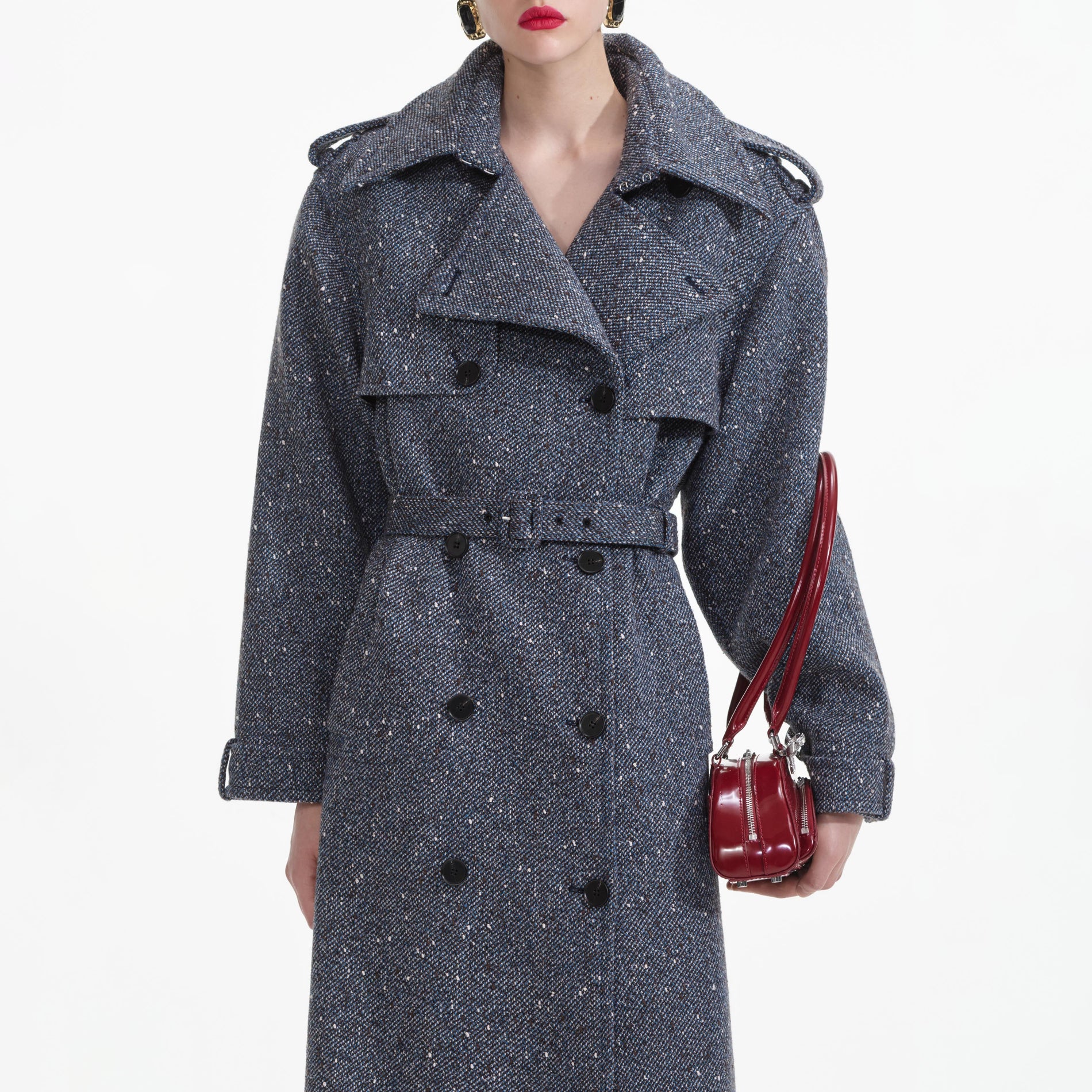 A close up of a woman wearing the Blue Boucle Trench Coat