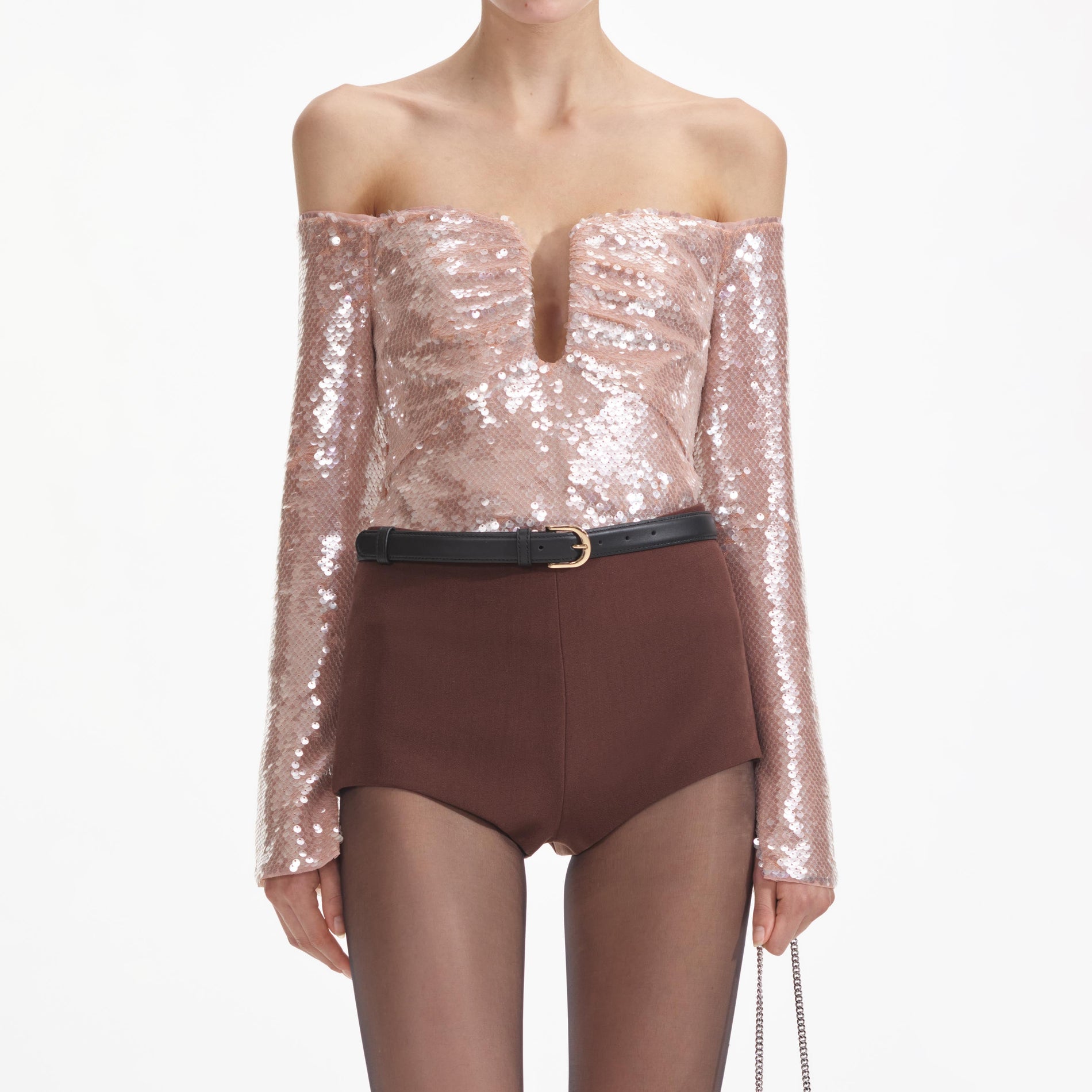 A close up of a woman wearing the Sequin Off Shoulder Top