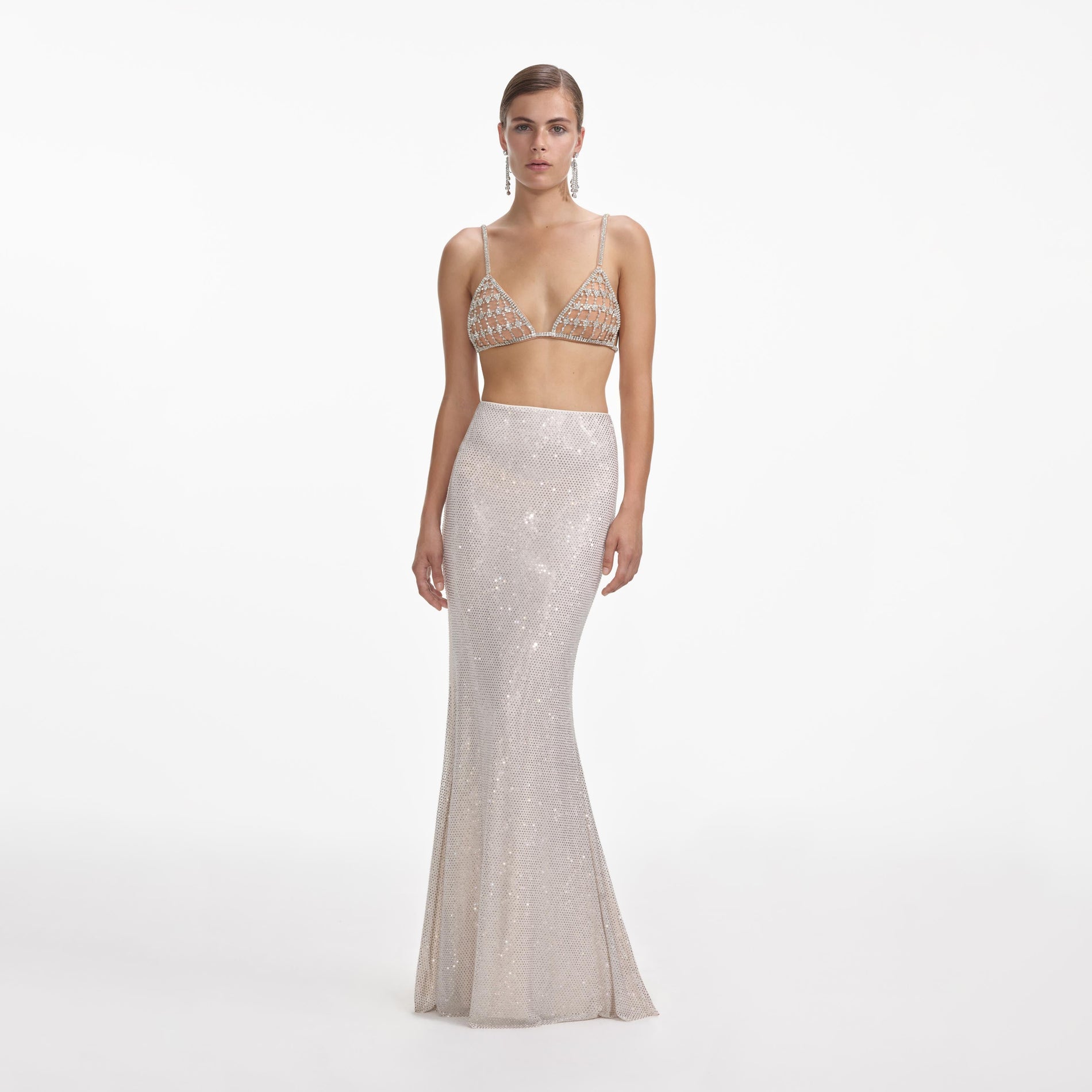 Front view of a woman wearing the Silver Rhinestone Mesh Maxi Skirt