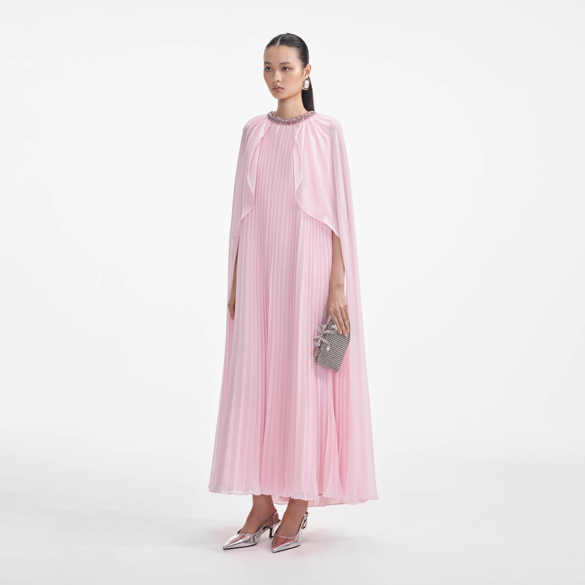 Side view of a woman wearing the Pink Chiffon Cape Midi Dress