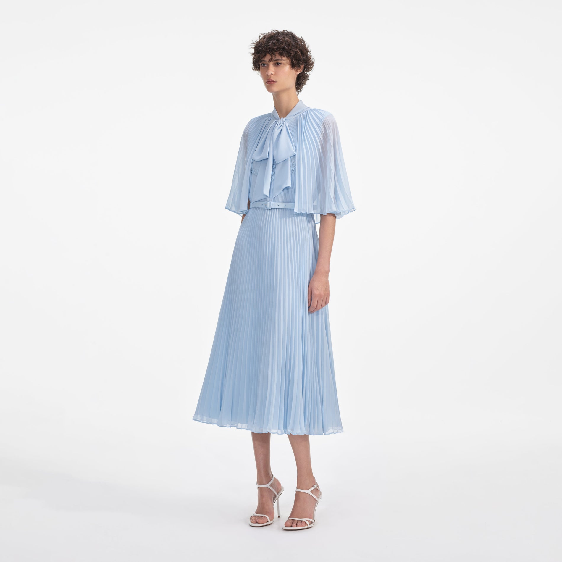 Side view of a woman wearing the Blue Chiffon Cape Midi Dress