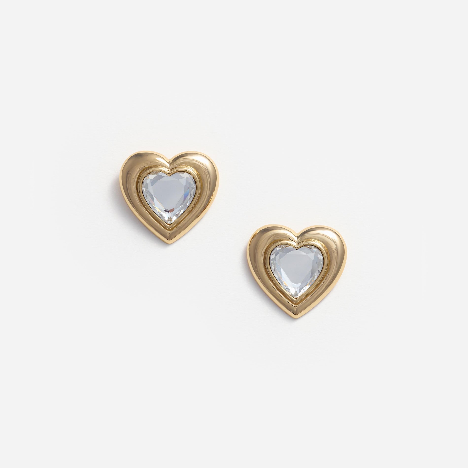 Front view of a woman wearing the Gold Crystal Heart Earrings