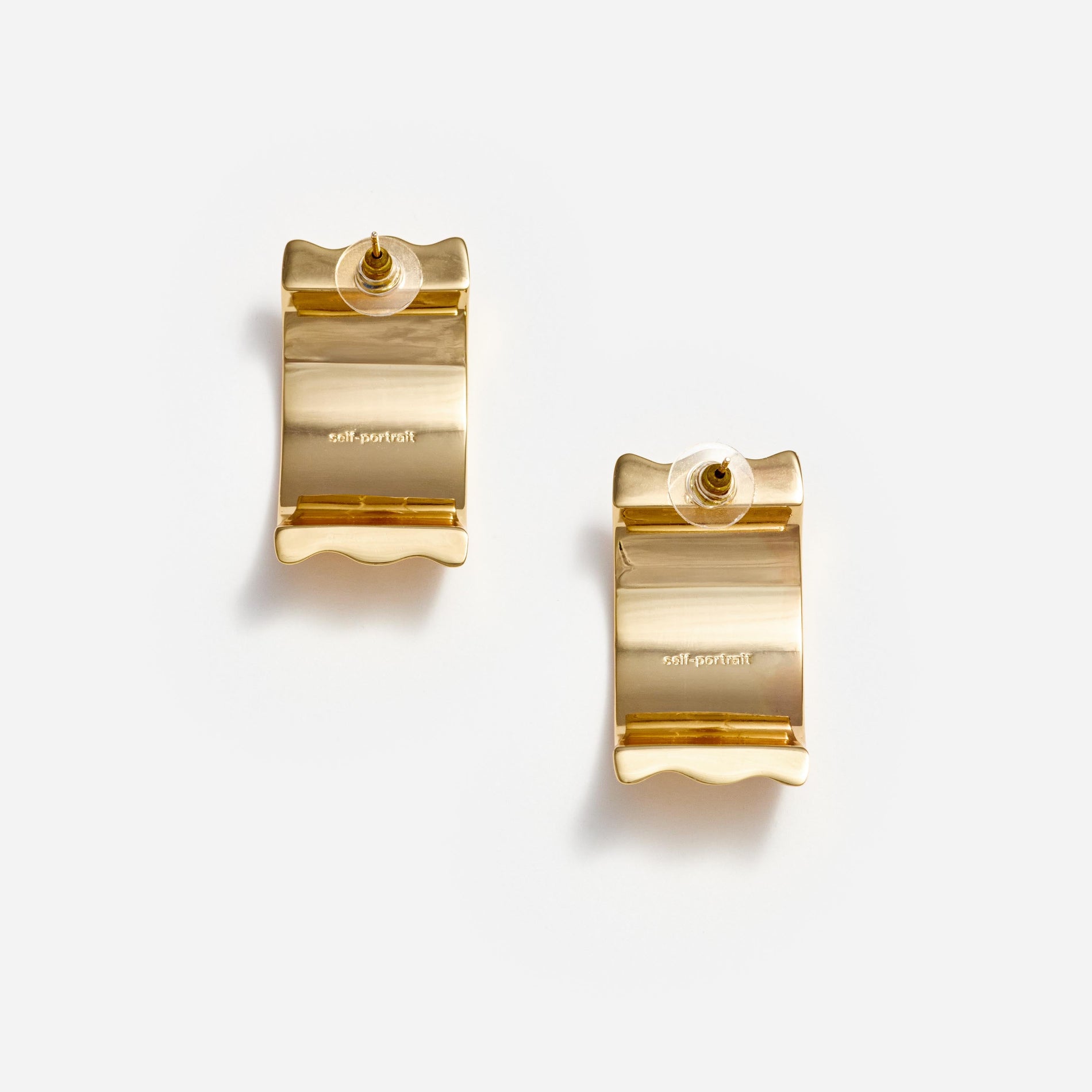 Back view of a woman wearing the Gold Ridged Earrings
