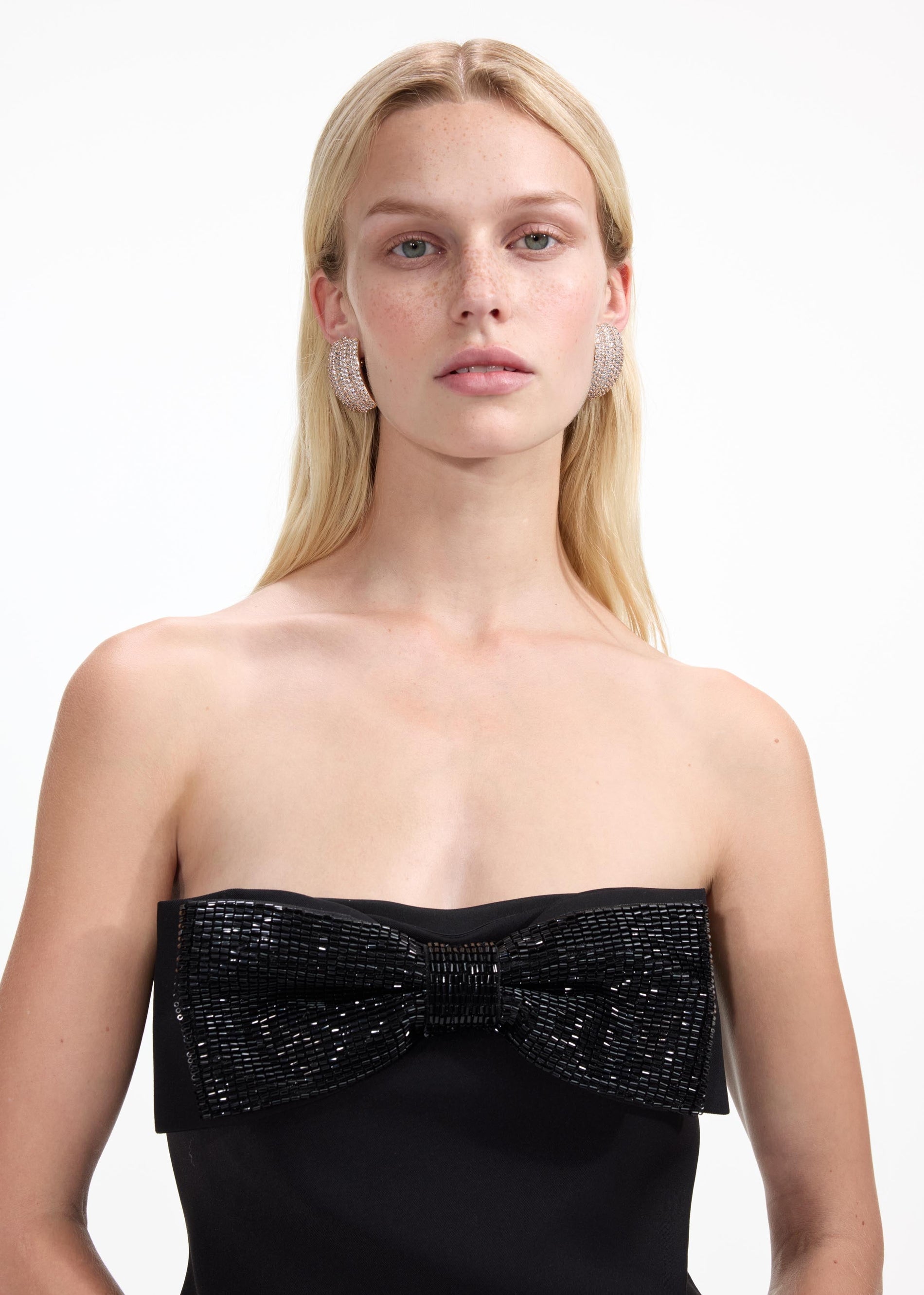 A close up of a woman wearing the Gold Crystal Ridged Earrings