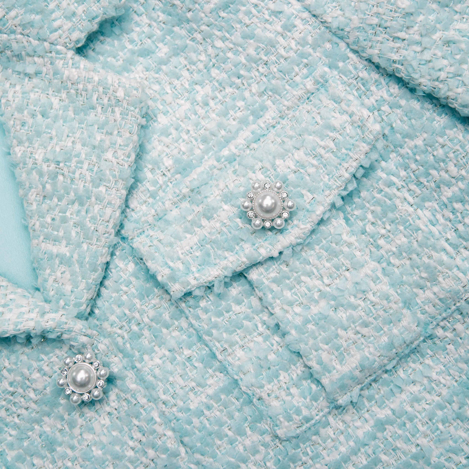 Back view of a woman wearing the Blue Boucle Jacket