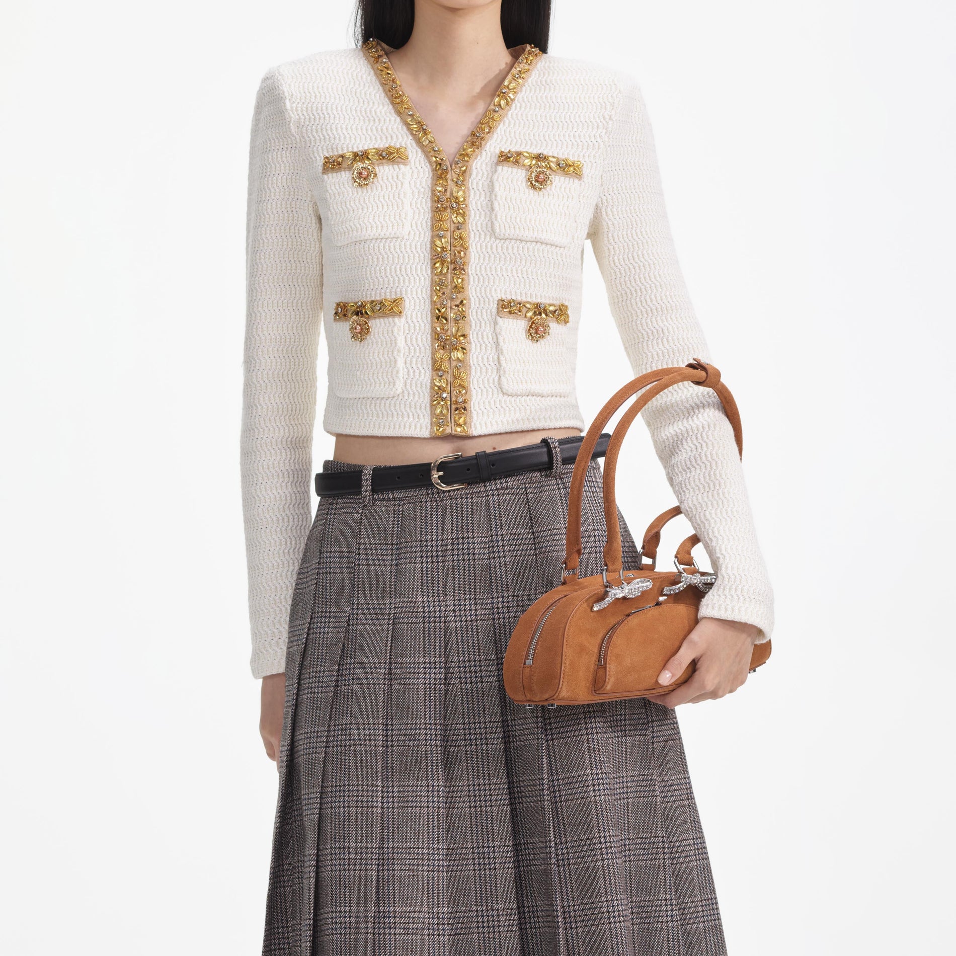 A close up of a woman wearing the Cream Lurex Knit Cardigan