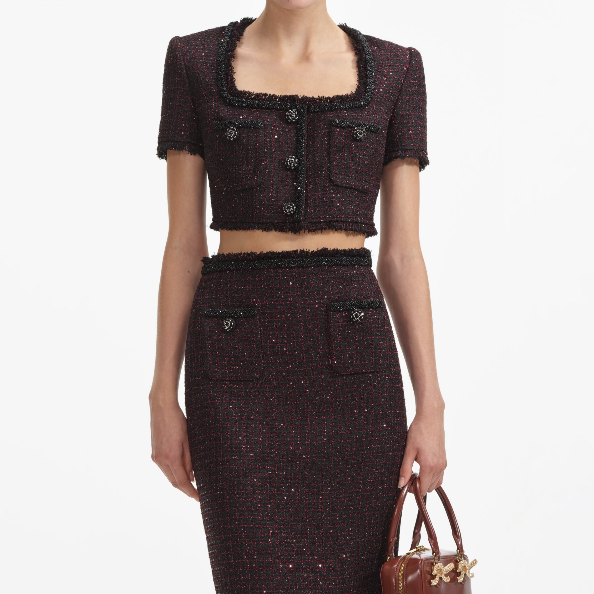 A close up of a woman wearing the Black Metallic Boucle Midi Skirt