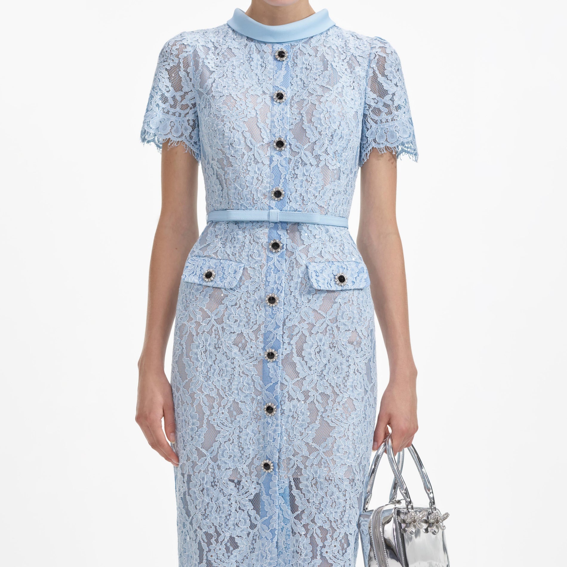 A close up of a woman wearing the Blue Lace Button Midi Dress