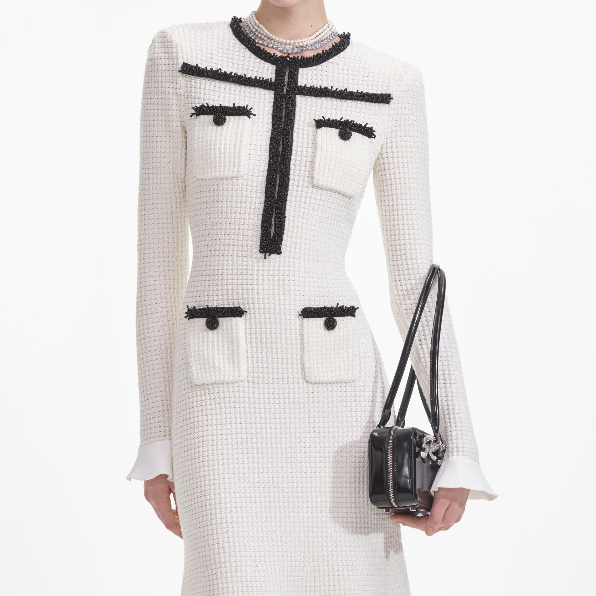 A close up of a woman wearing the White Knit Contrast Trim Midi Dress