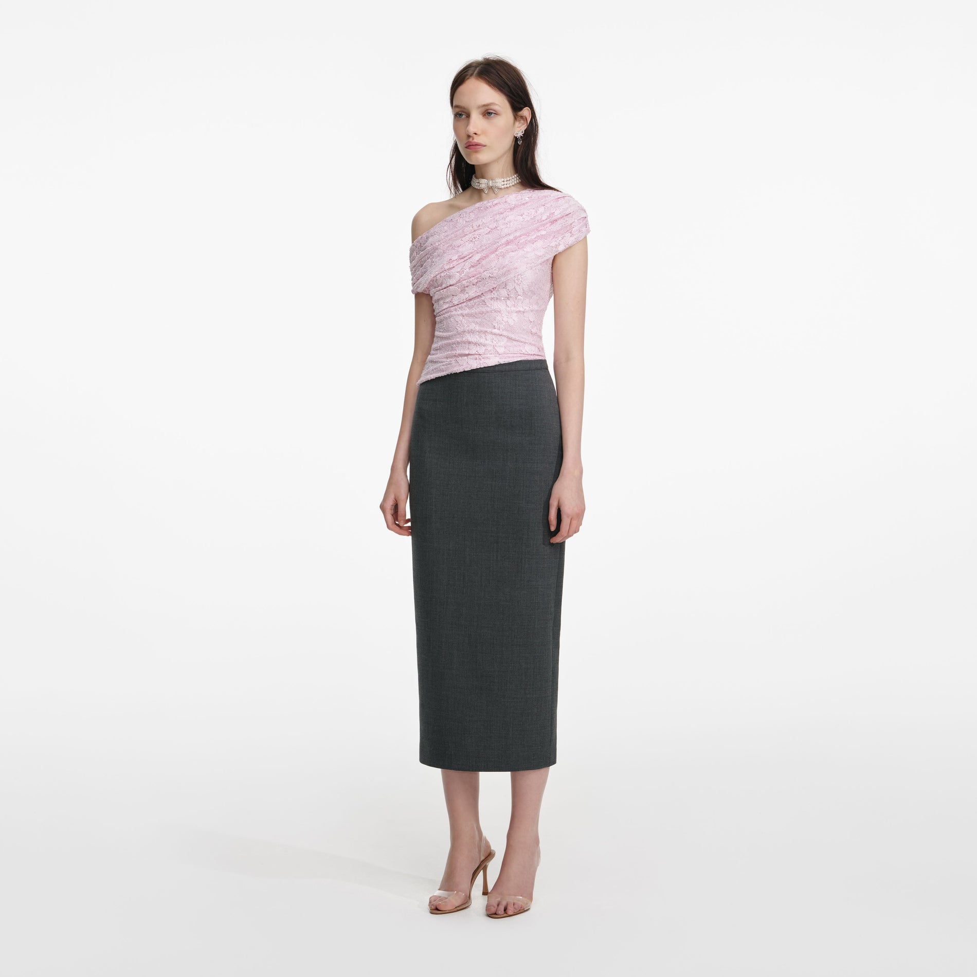 Side view of a woman wearing the Pink Rhinestone Lace Drape Top