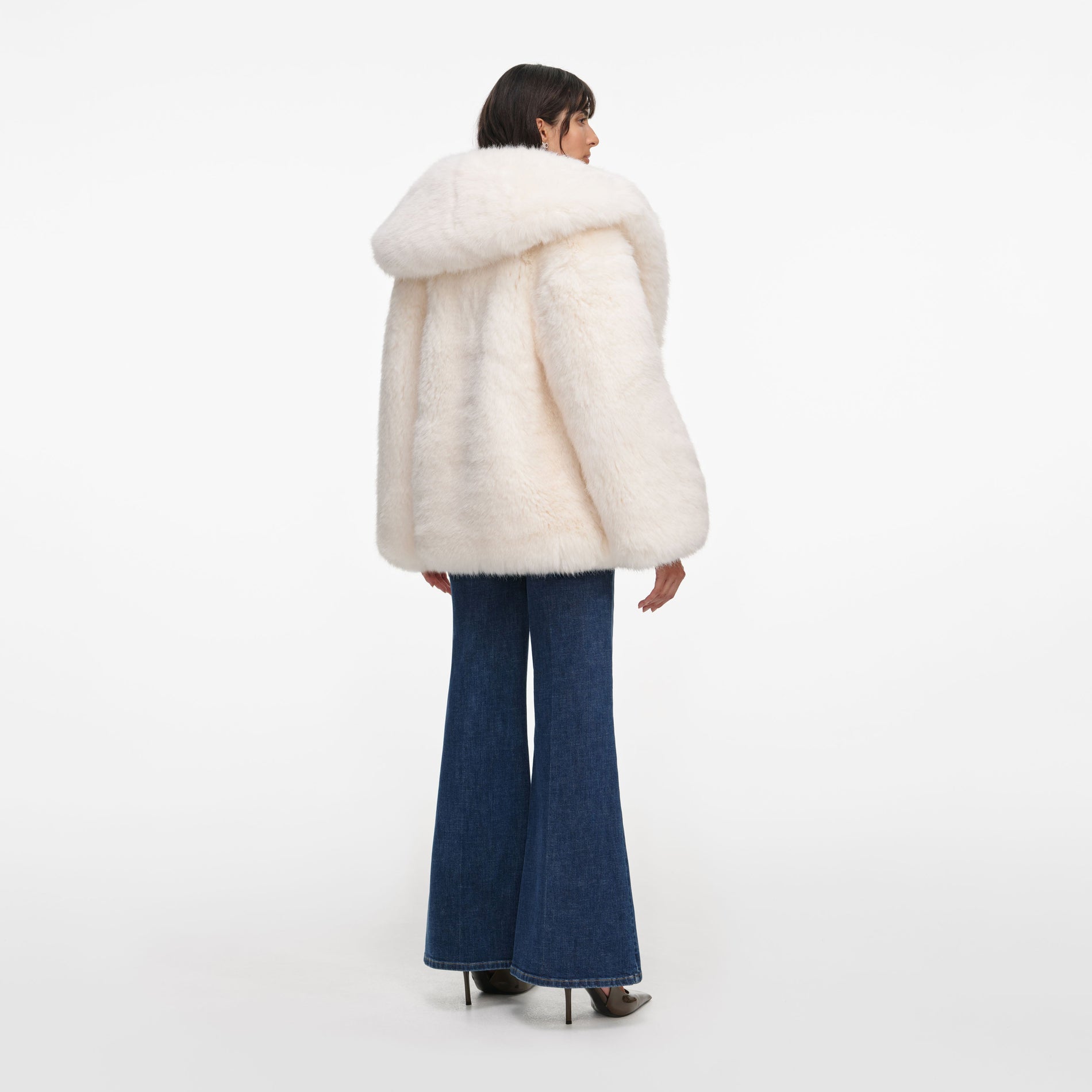 Back view of a woman wearing the White Faux Fur Coat
