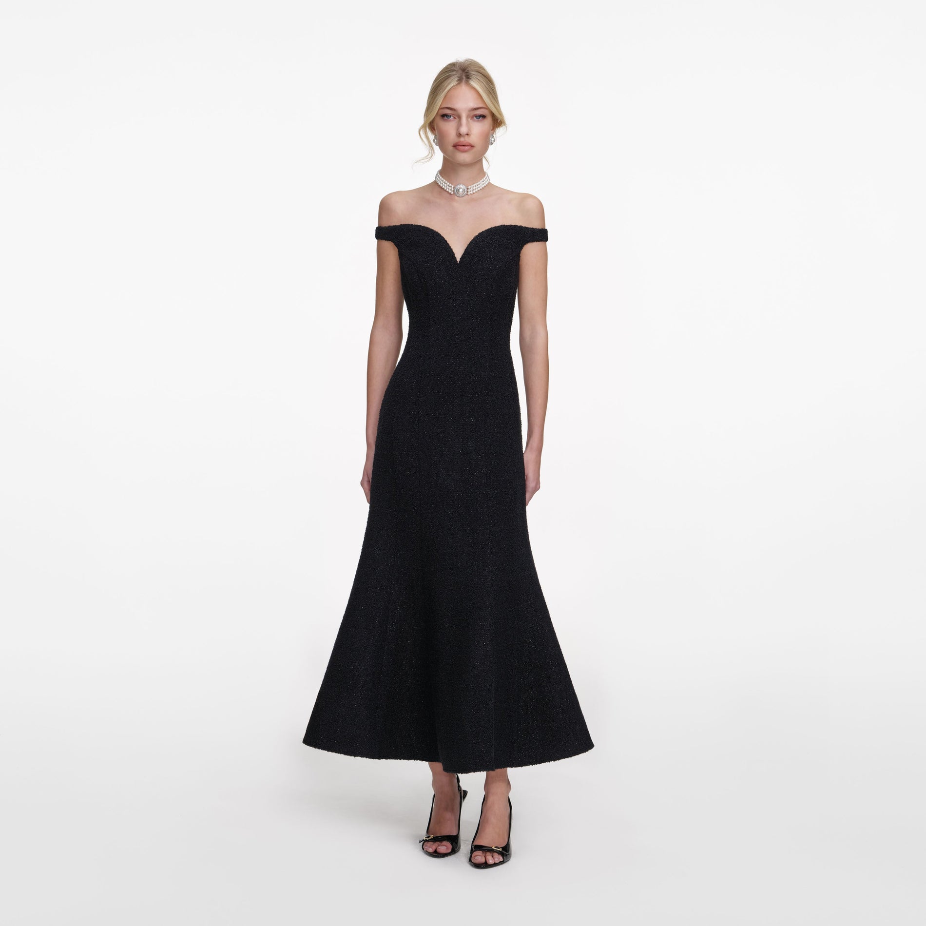 Front view of a woman wearing the Black Boucle Midi Dress