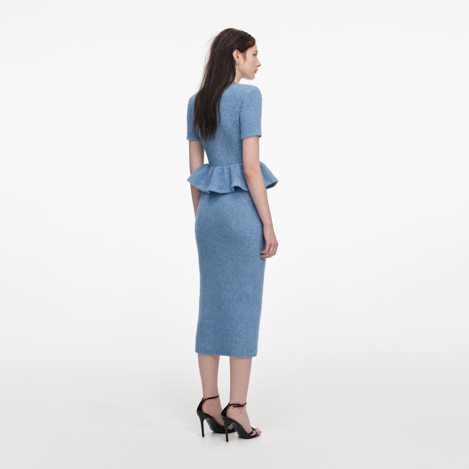Back view of a woman wearing the Blue Peplum Knit Midi Dress