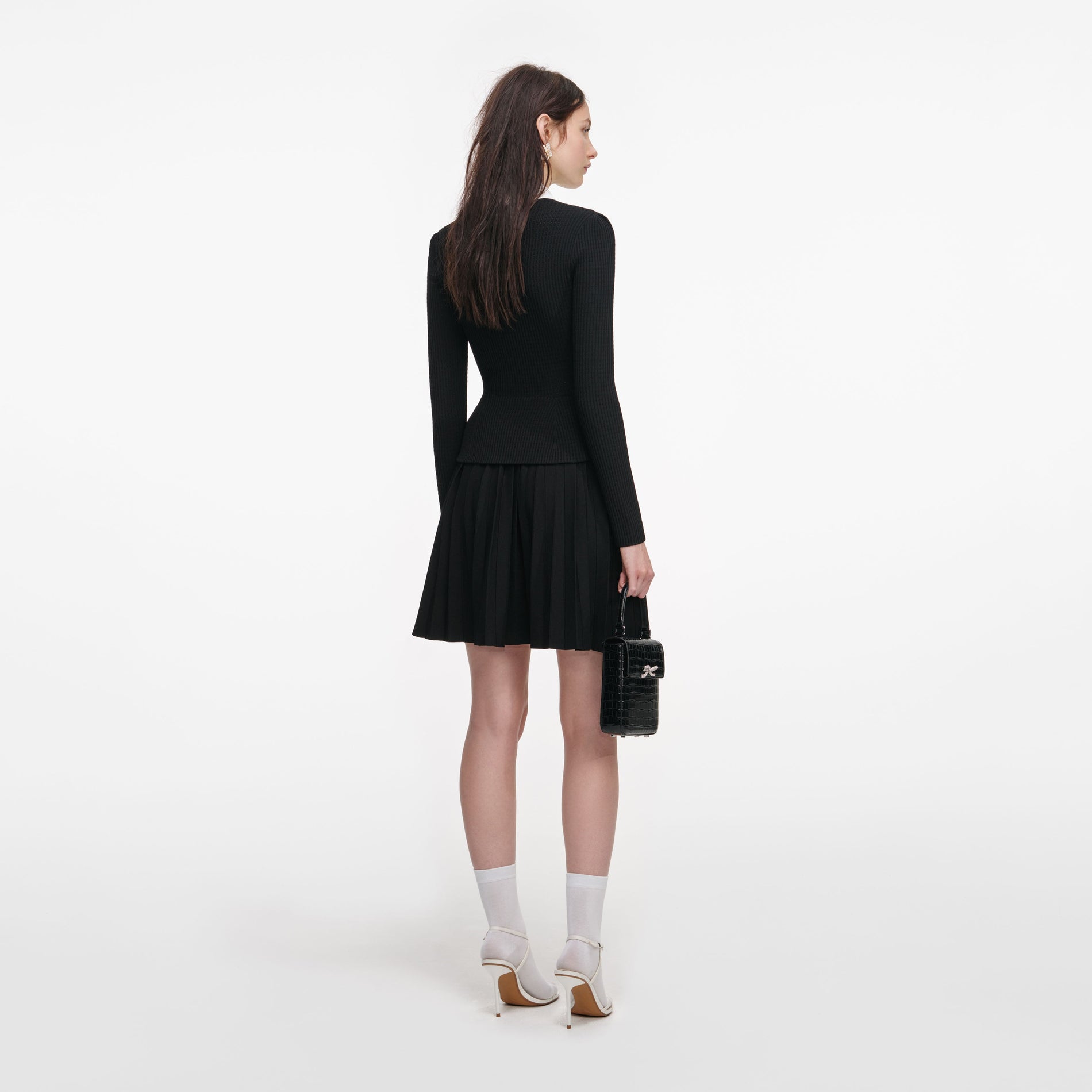 Back view of a woman wearing the Black Tailored Knit Mini Dress