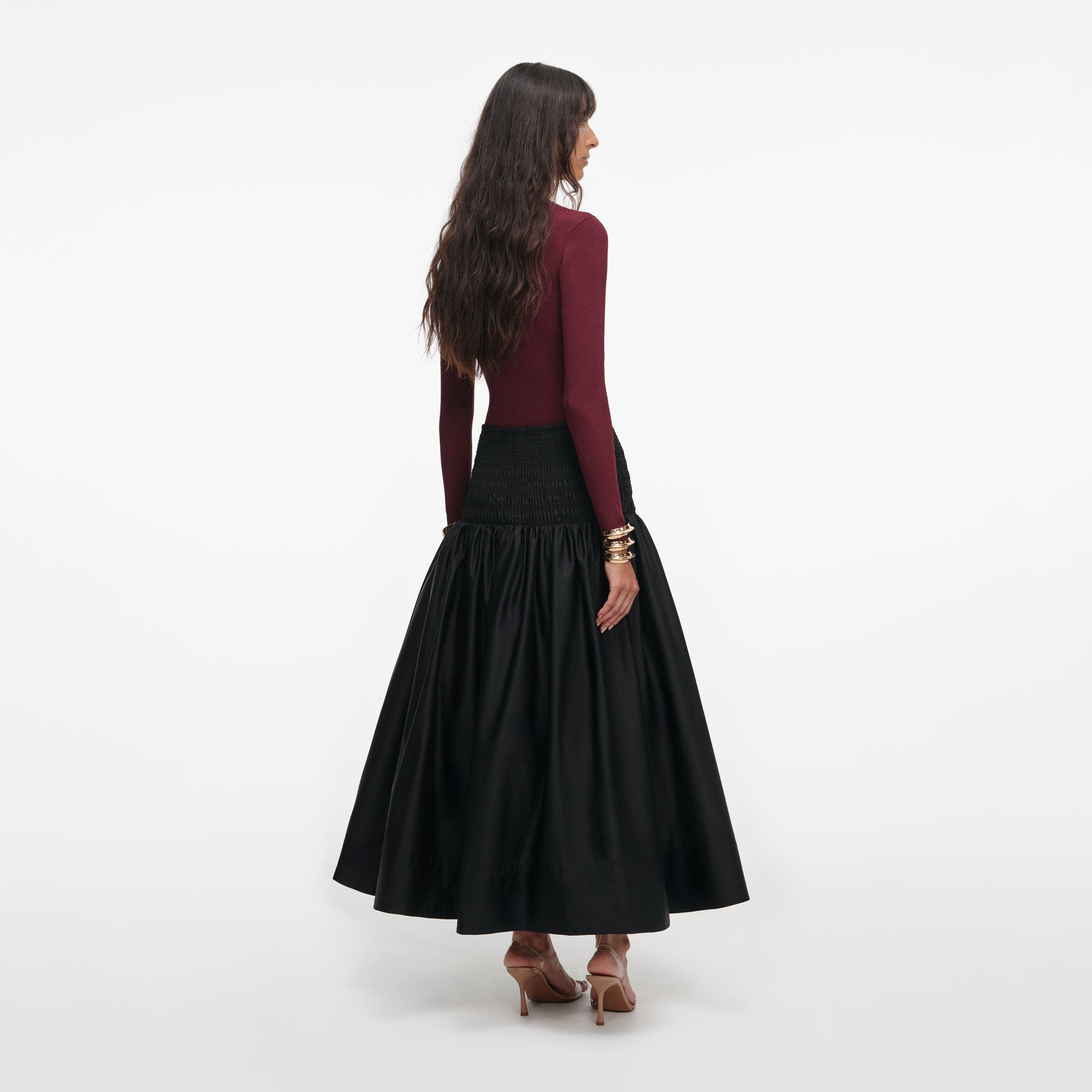 Back view of a woman wearing the Black Cotton Midi Skirt