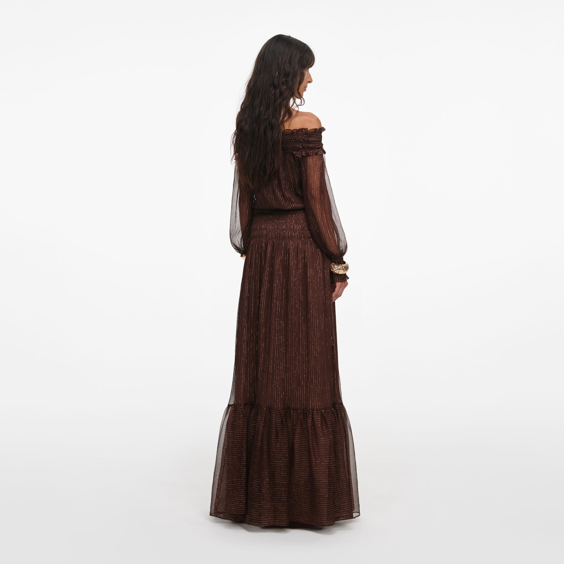 Back view of a woman wearing the Brown Georgette Off Shoulder Maxi Dress