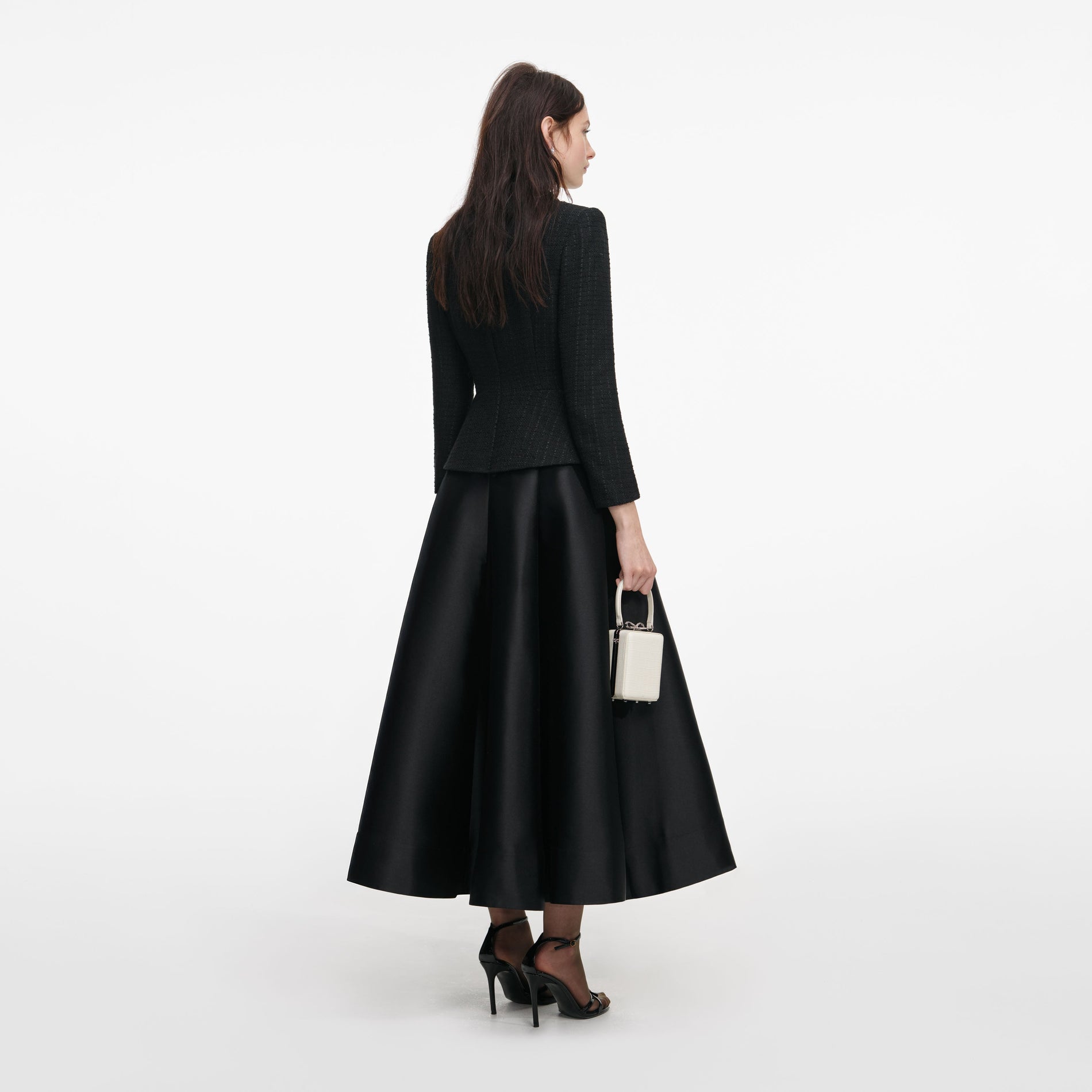 Back view of a woman wearing the Black Boucle Taffeta Midi Dress