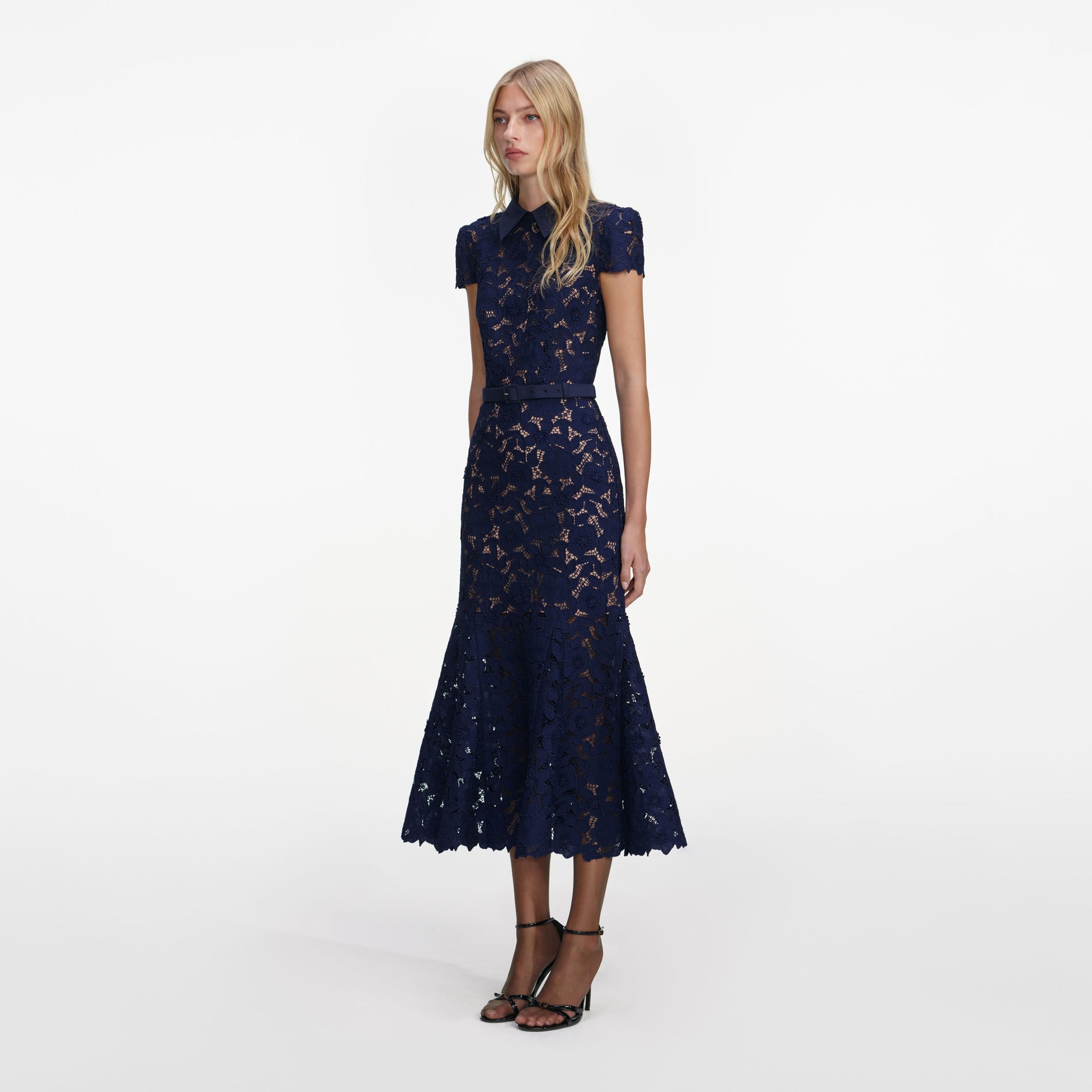 Side view of a woman wearing the Navy Guipure Lace Midi Dress
