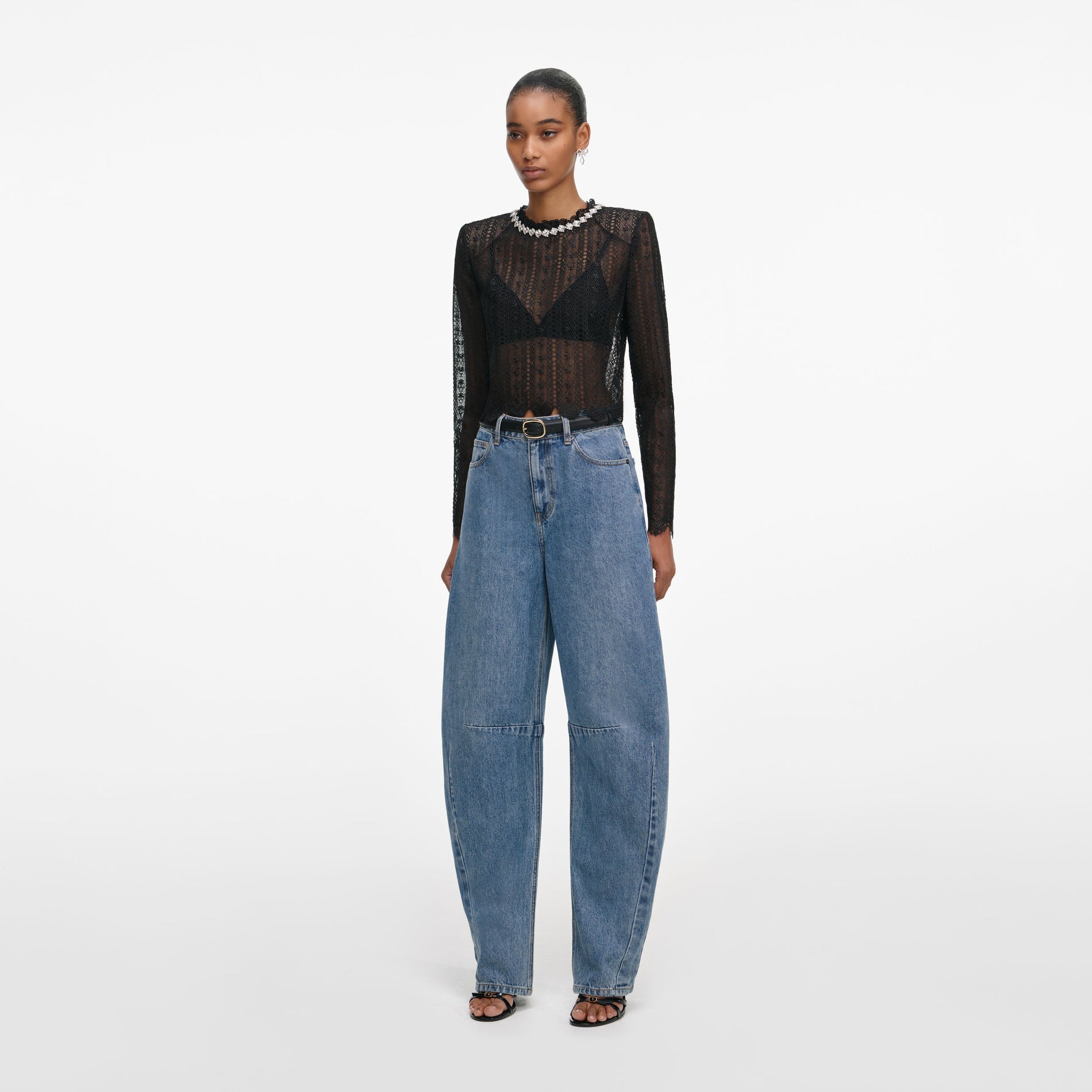 Side view of a woman wearing the Black Organza Lace Top