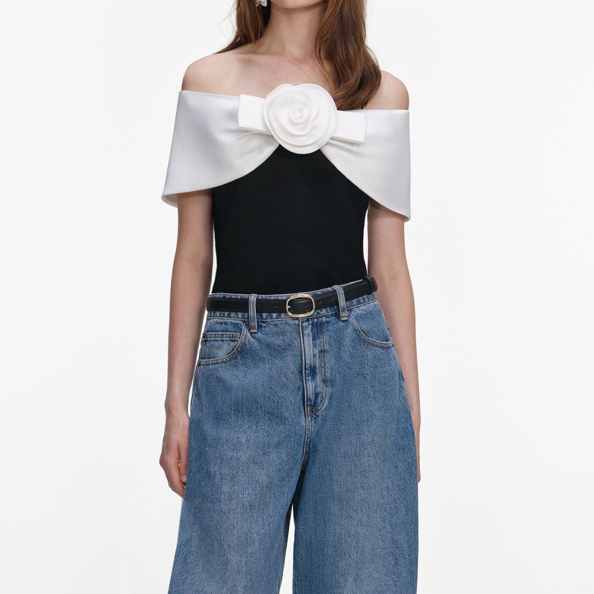 A close up of a woman wearing the Black Crepe Flower Top