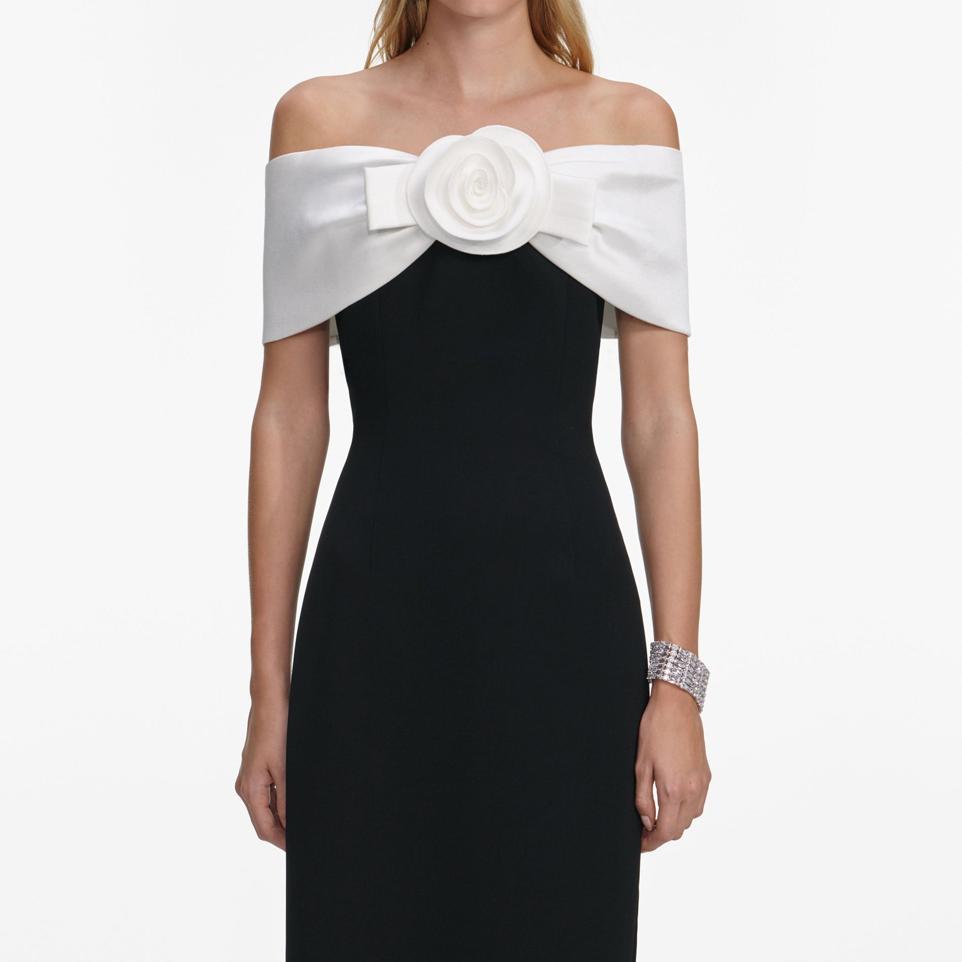 A close up of a woman wearing the Black Crepe Flower Maxi Dress