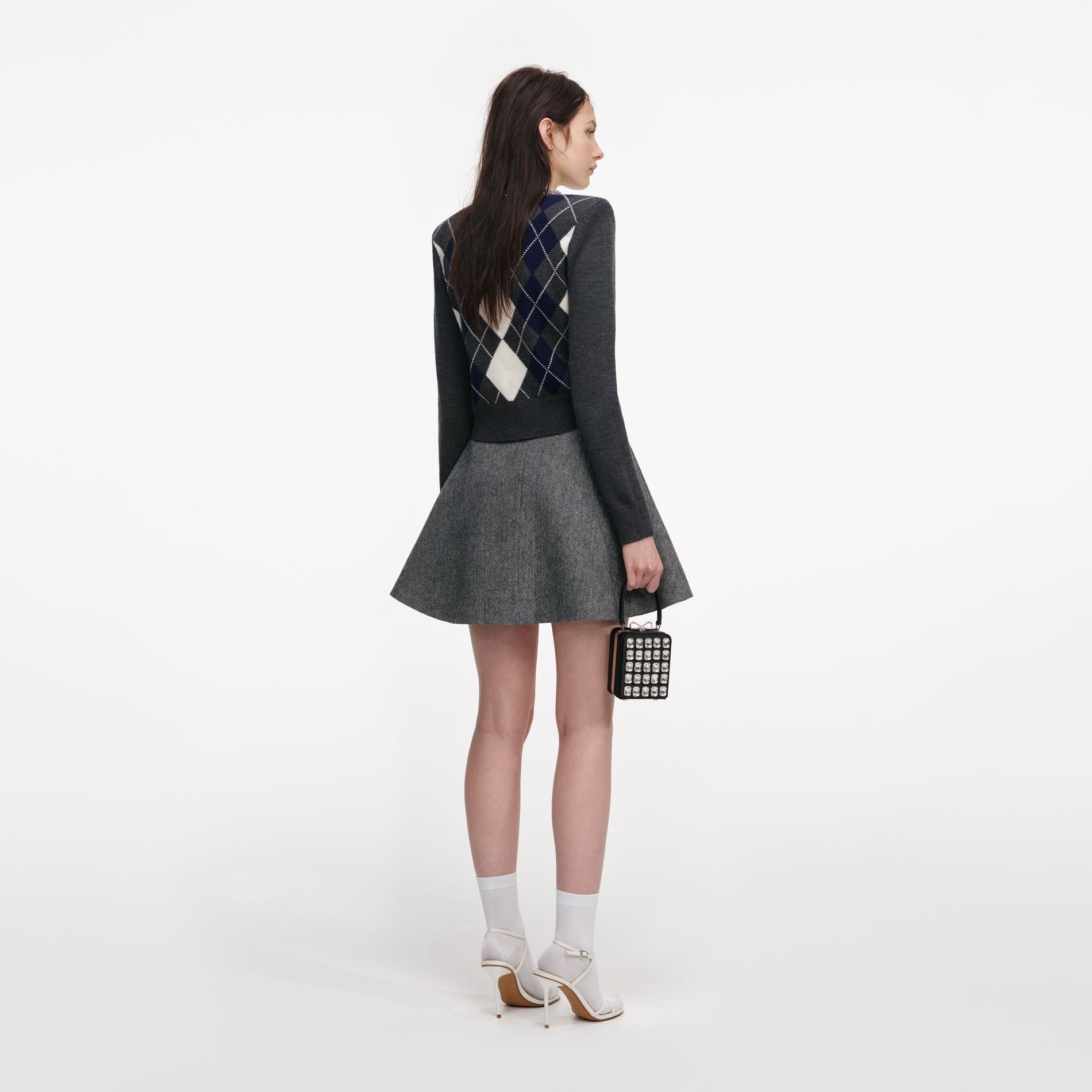 Back view of a woman wearing the Grey Argyle Crystal Trim Jumper