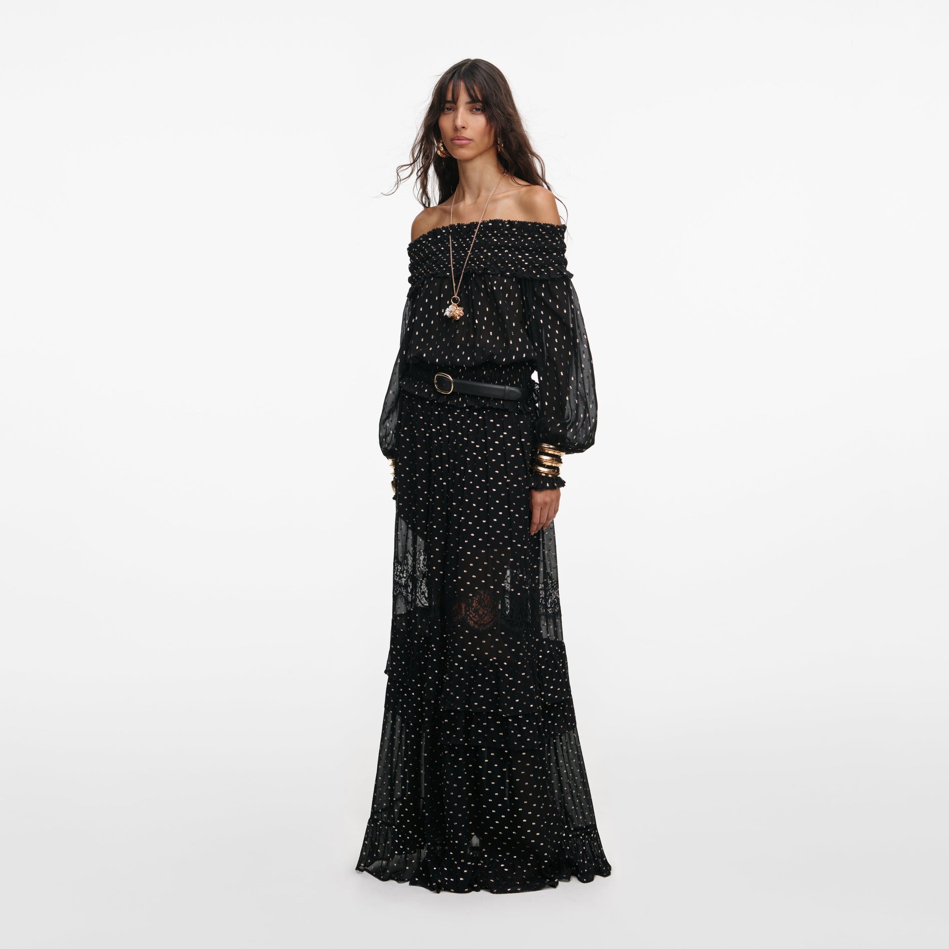 Side view of a woman wearing the Black And Gold Chiffon Lace Maxi Skirt